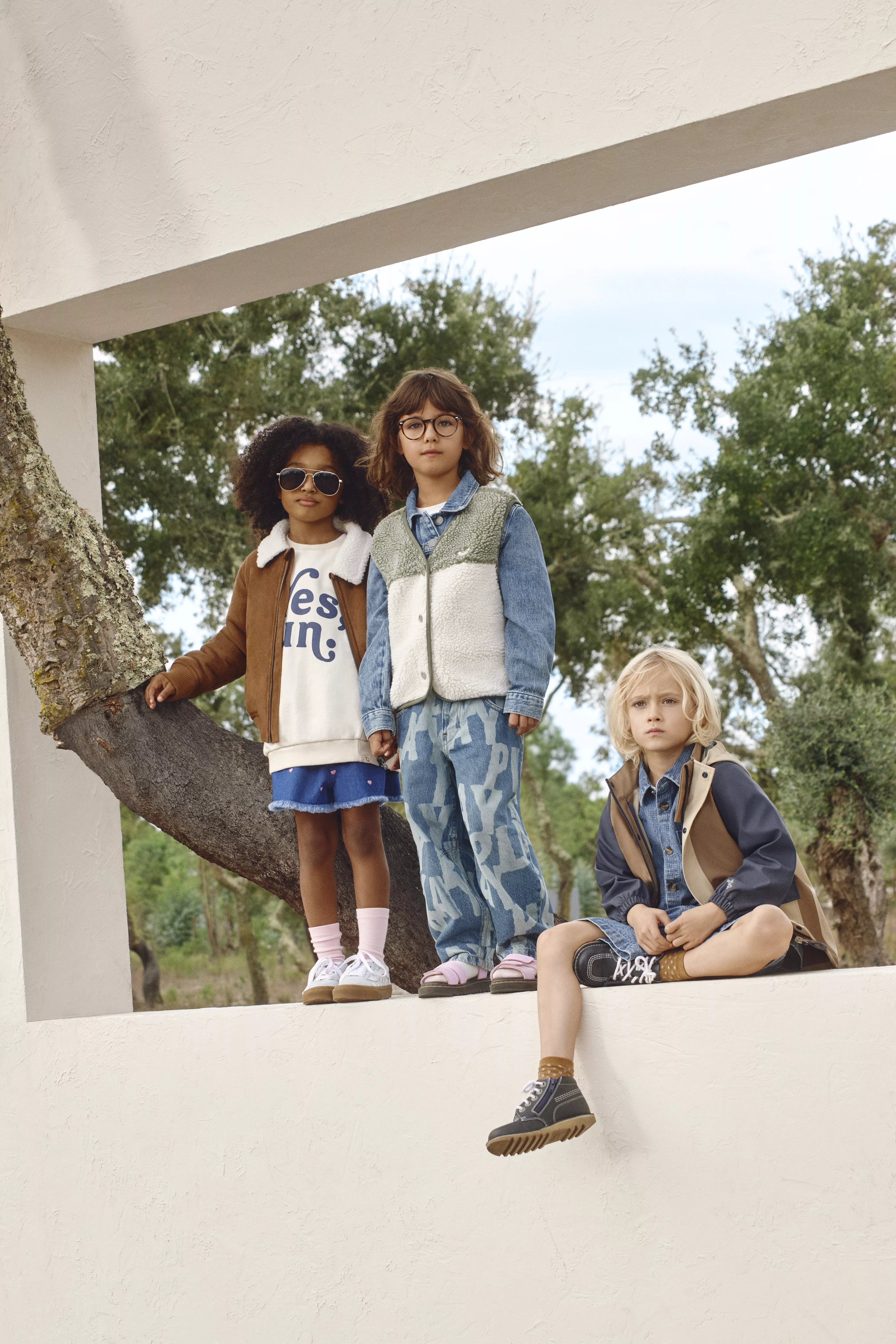 three kids wearing denim outfits in woodland area