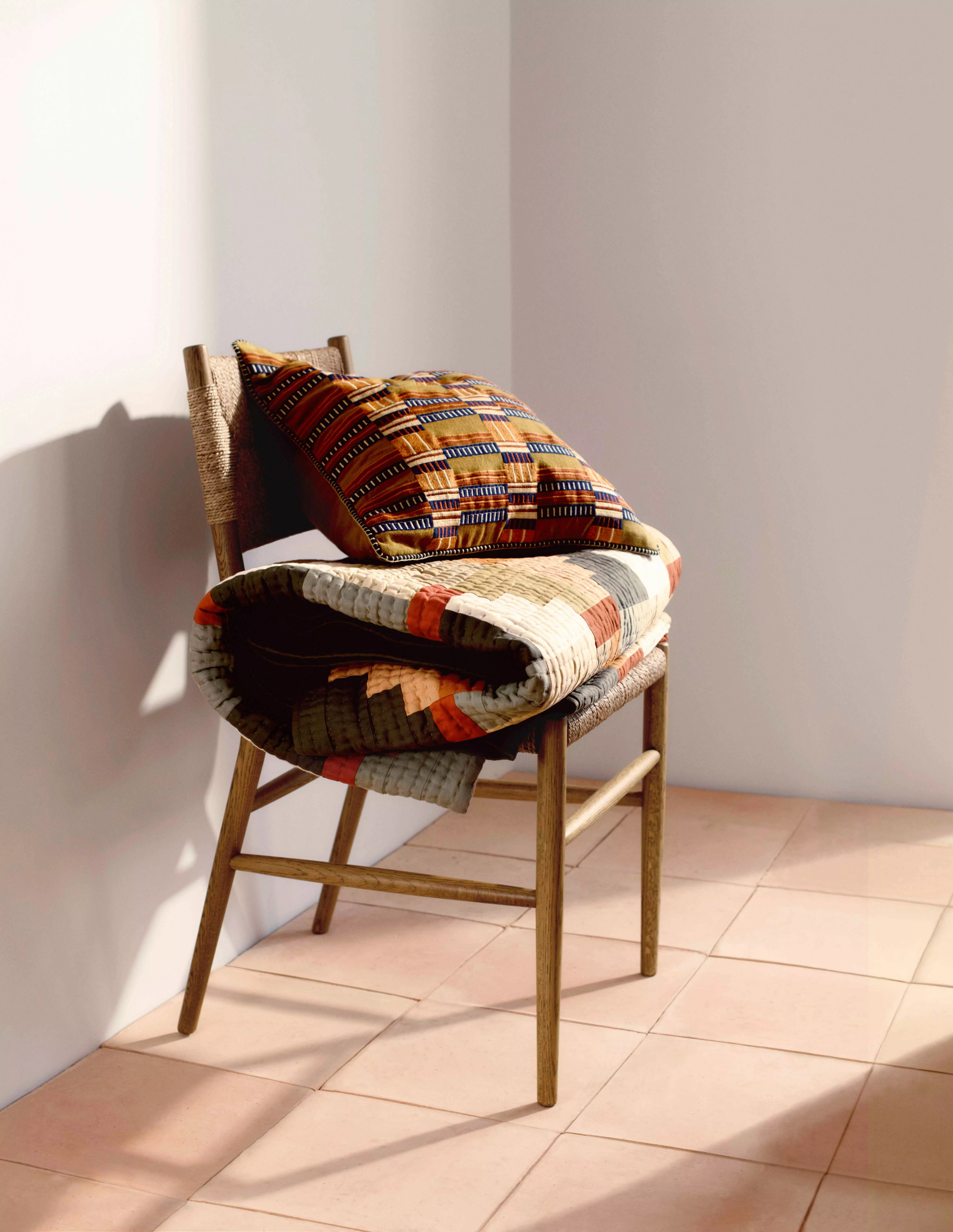 multi coloured check bedspread on a bed