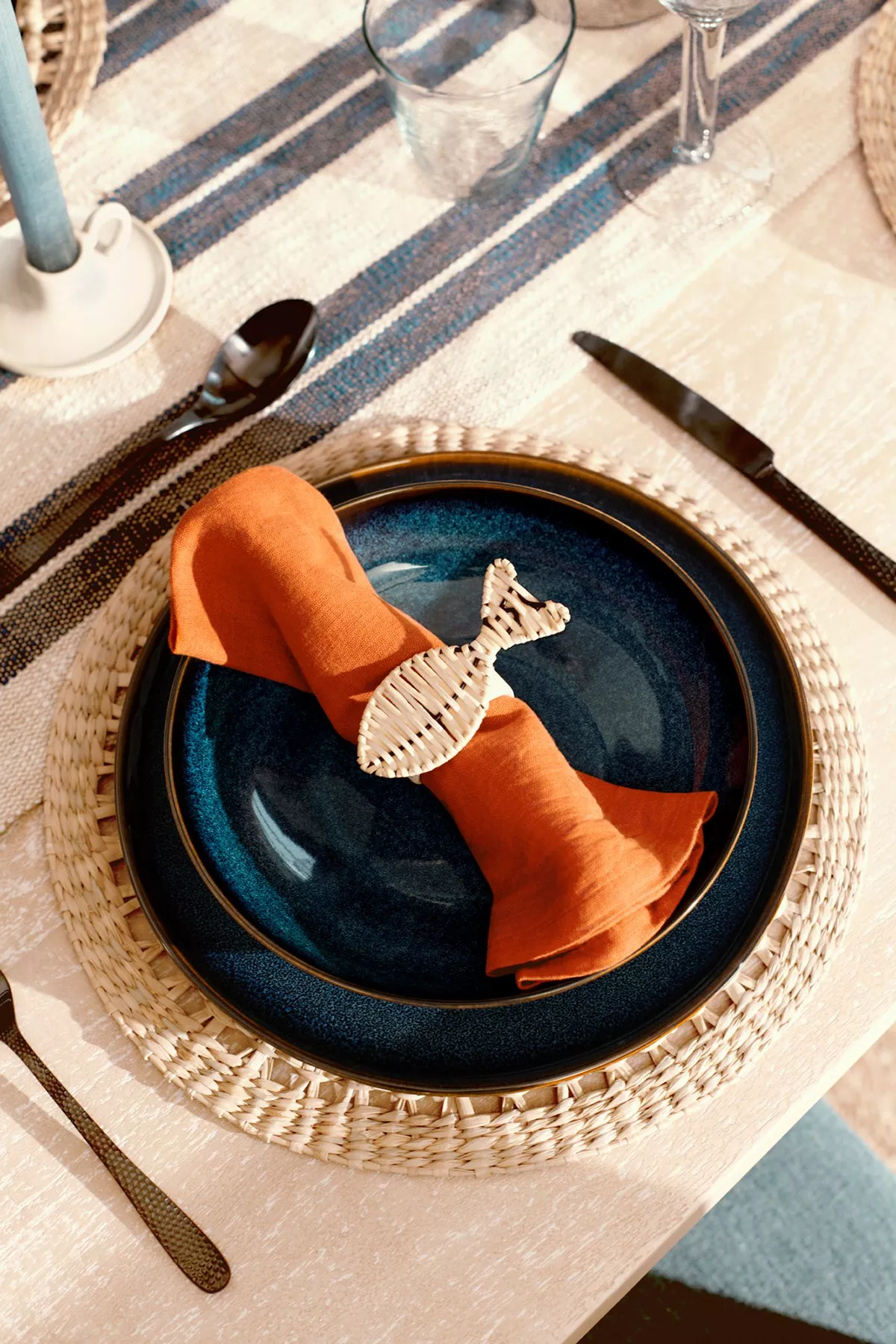 An overhead shot of ceramic bowls with a geometric black and white design on a tiled surface, with a pink dragon fruit