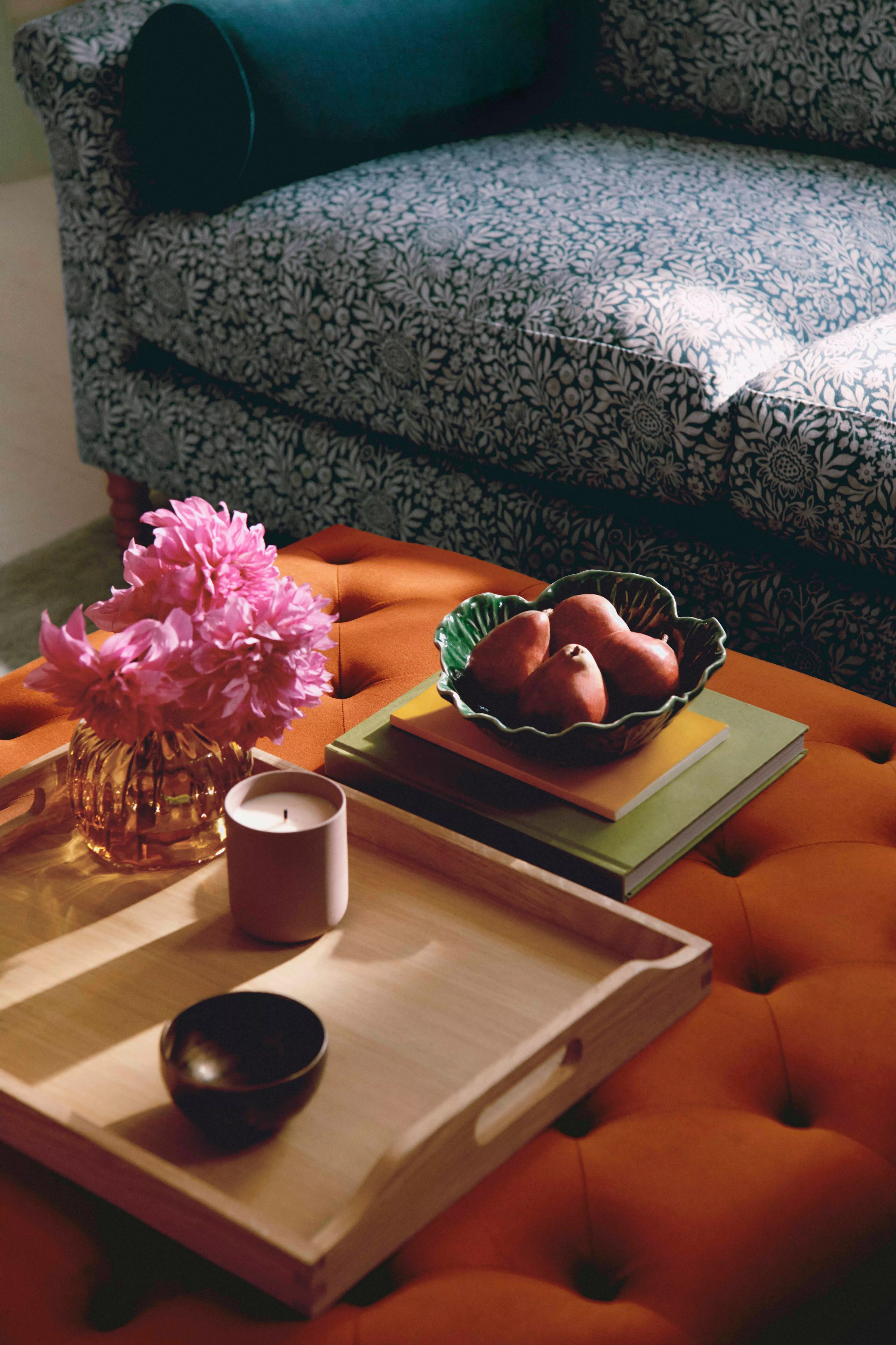Orange footstool with a tray sitting on it