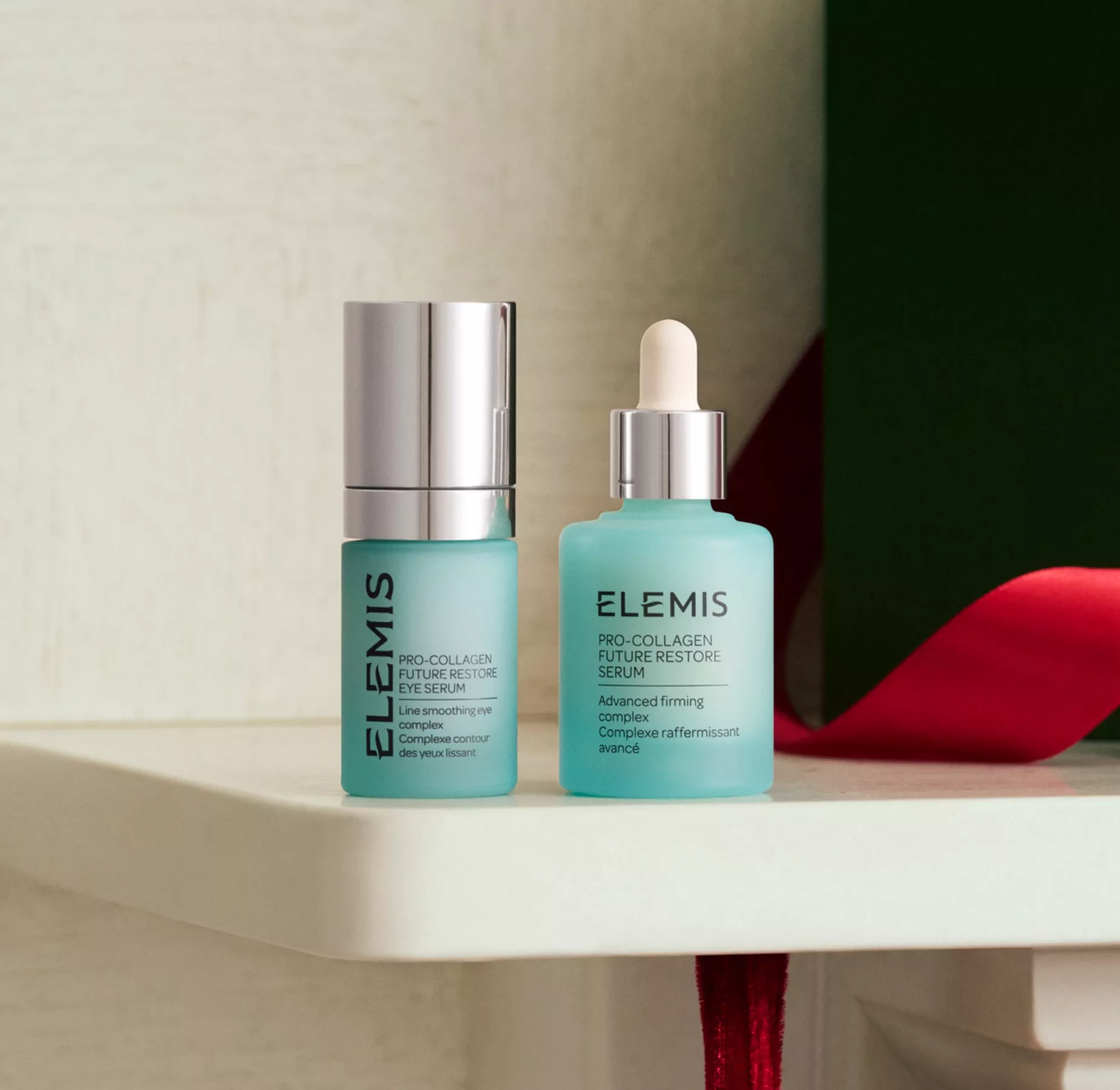 ELEMIS Pro-Collagen Future Restore Eye Serum and Face Serum bottles on shelf, luxury skincare product shot