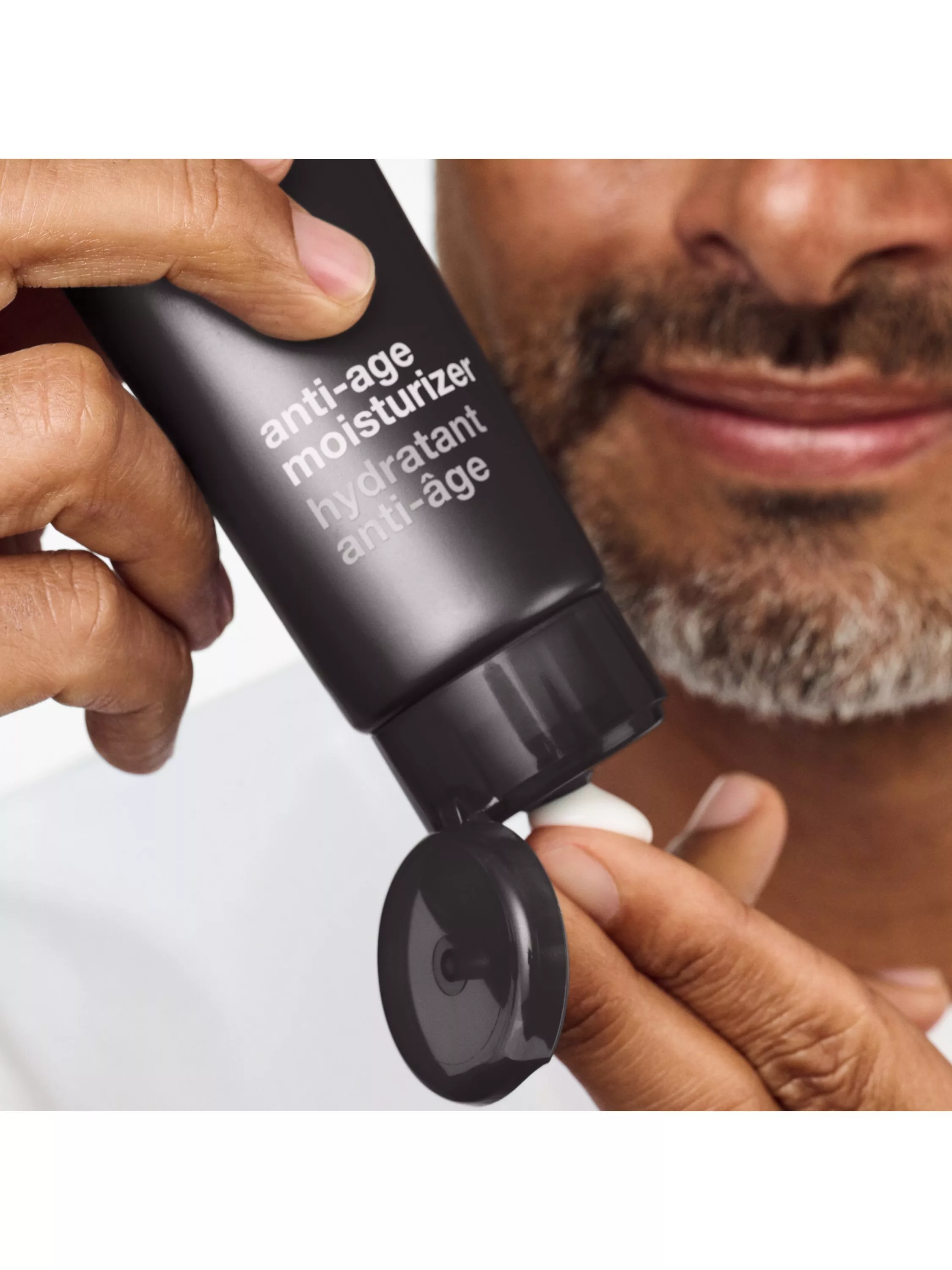man using moisturiser