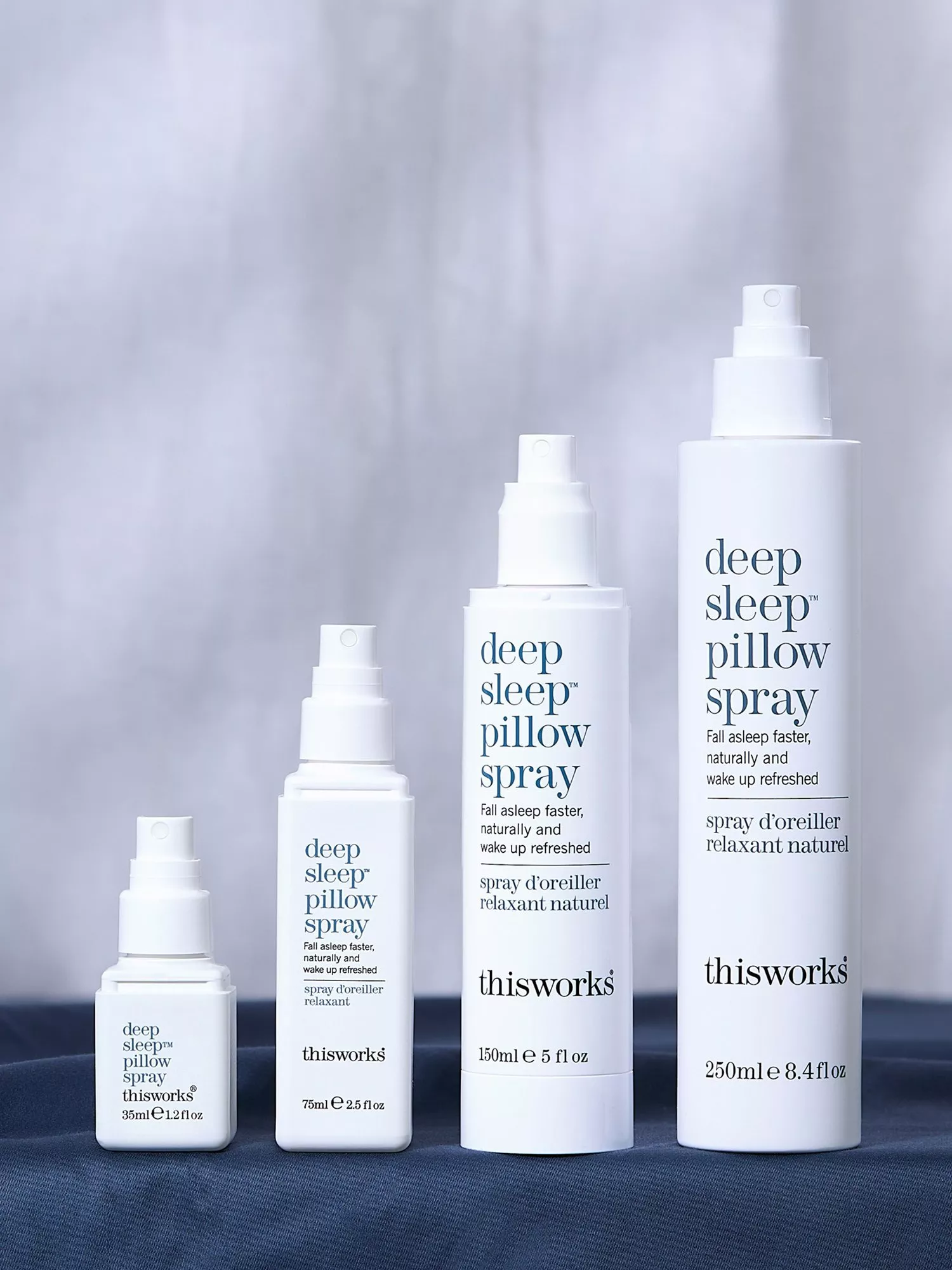 This Works Deep Sleep Pillow Spray bottles in multiple sizes, relaxing bedtime aromatherapy mist on display