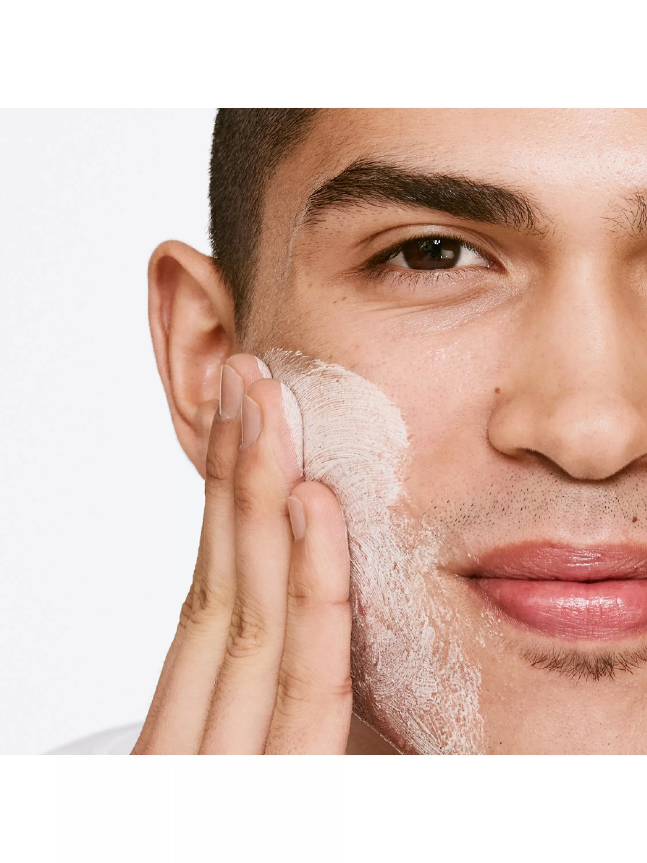 man washing face with cleanser