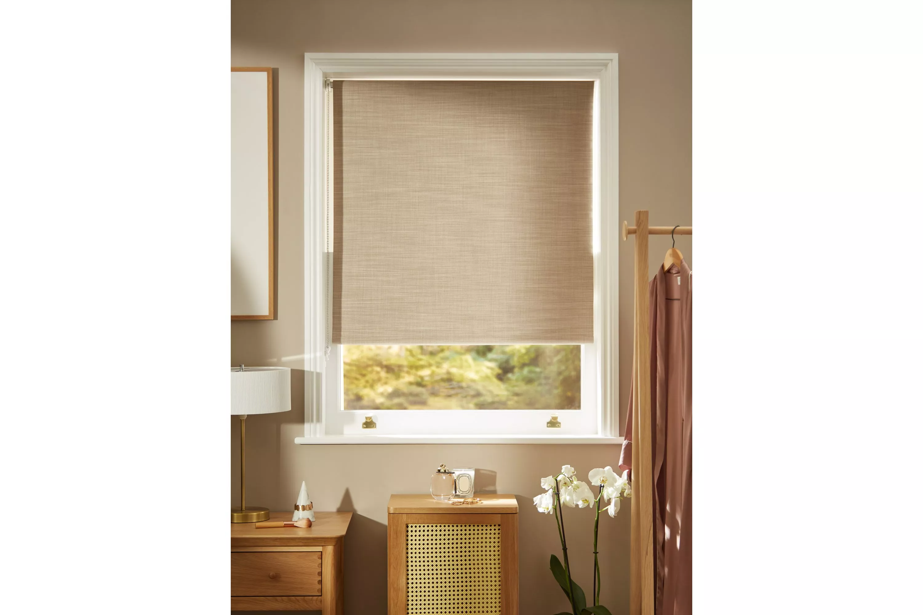 Beige linen roller blind on white framed window in modern bedroom, soft natural light and minimalist decor