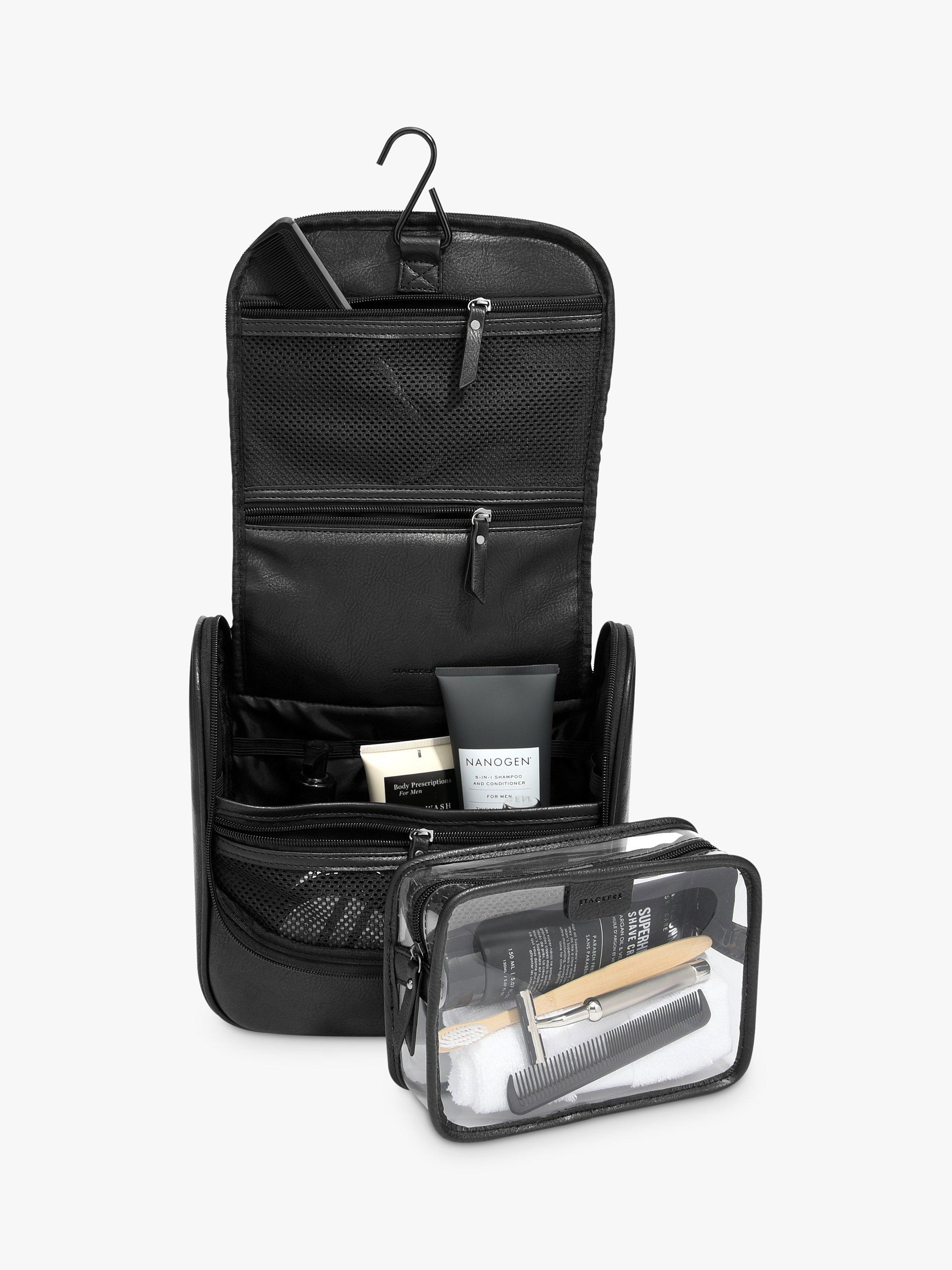 A black hanging travel bag and a black and clear bag