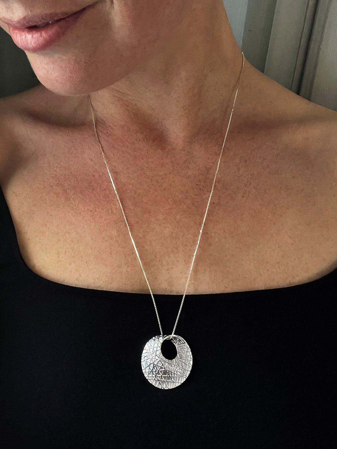 Product image 2 of 4, which shows Nina B Textured Mobious Round Pendant Necklace, Silver