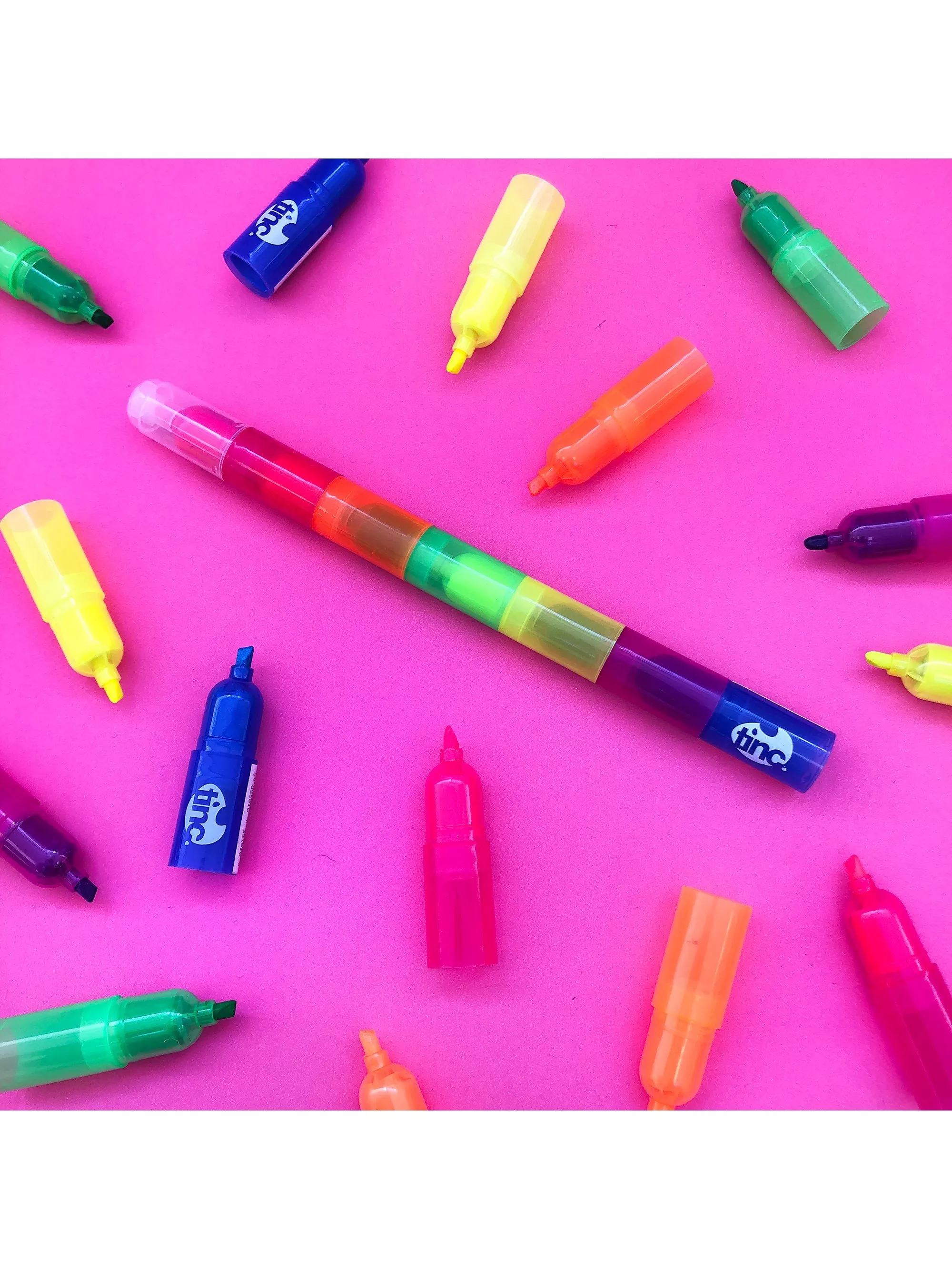 Multiple highlighter colours on a bright pink background