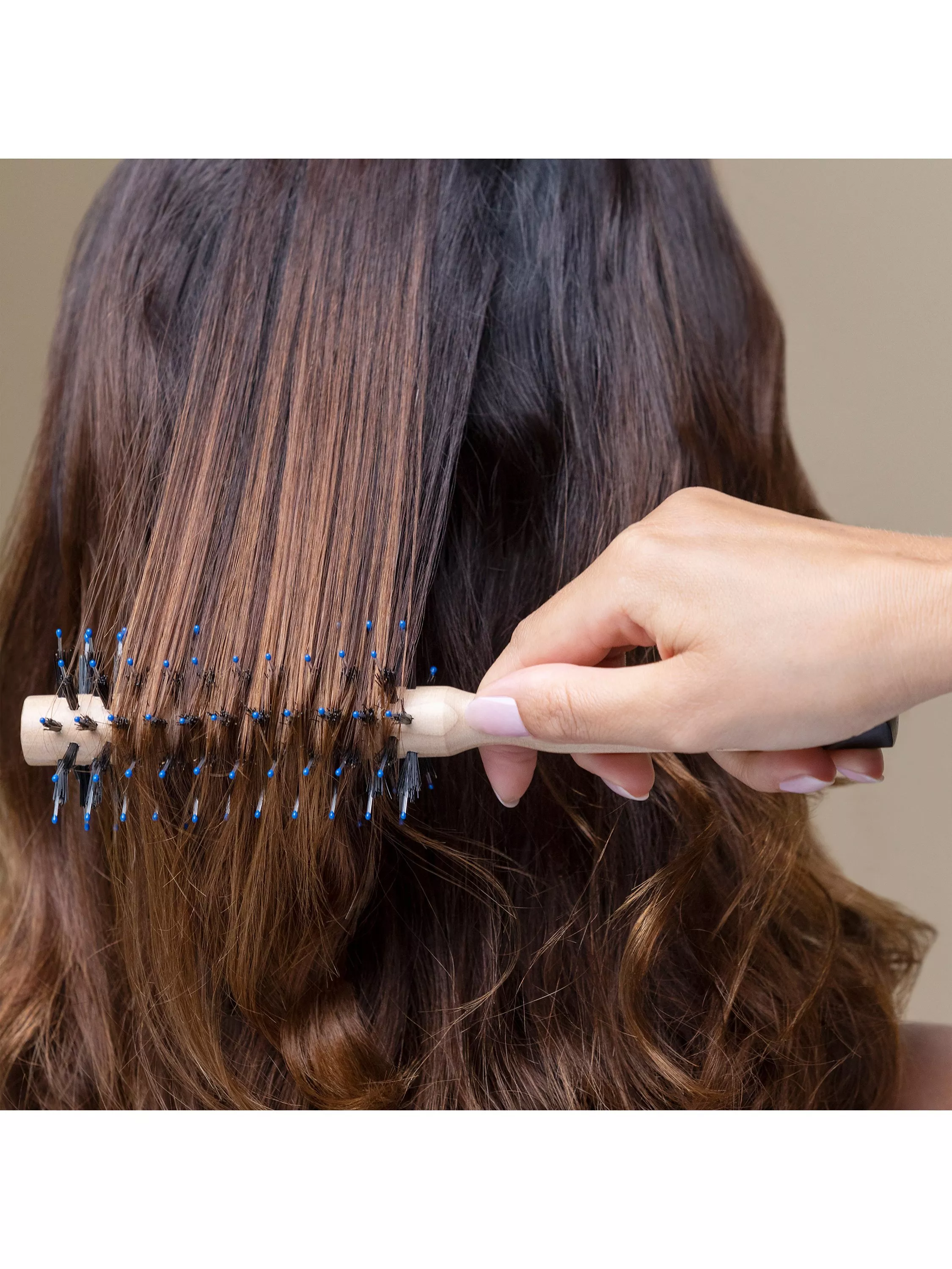 Close-up of paddle hairbrush detangling straight blonde hair, styling tool for smooth, tangle-free finish