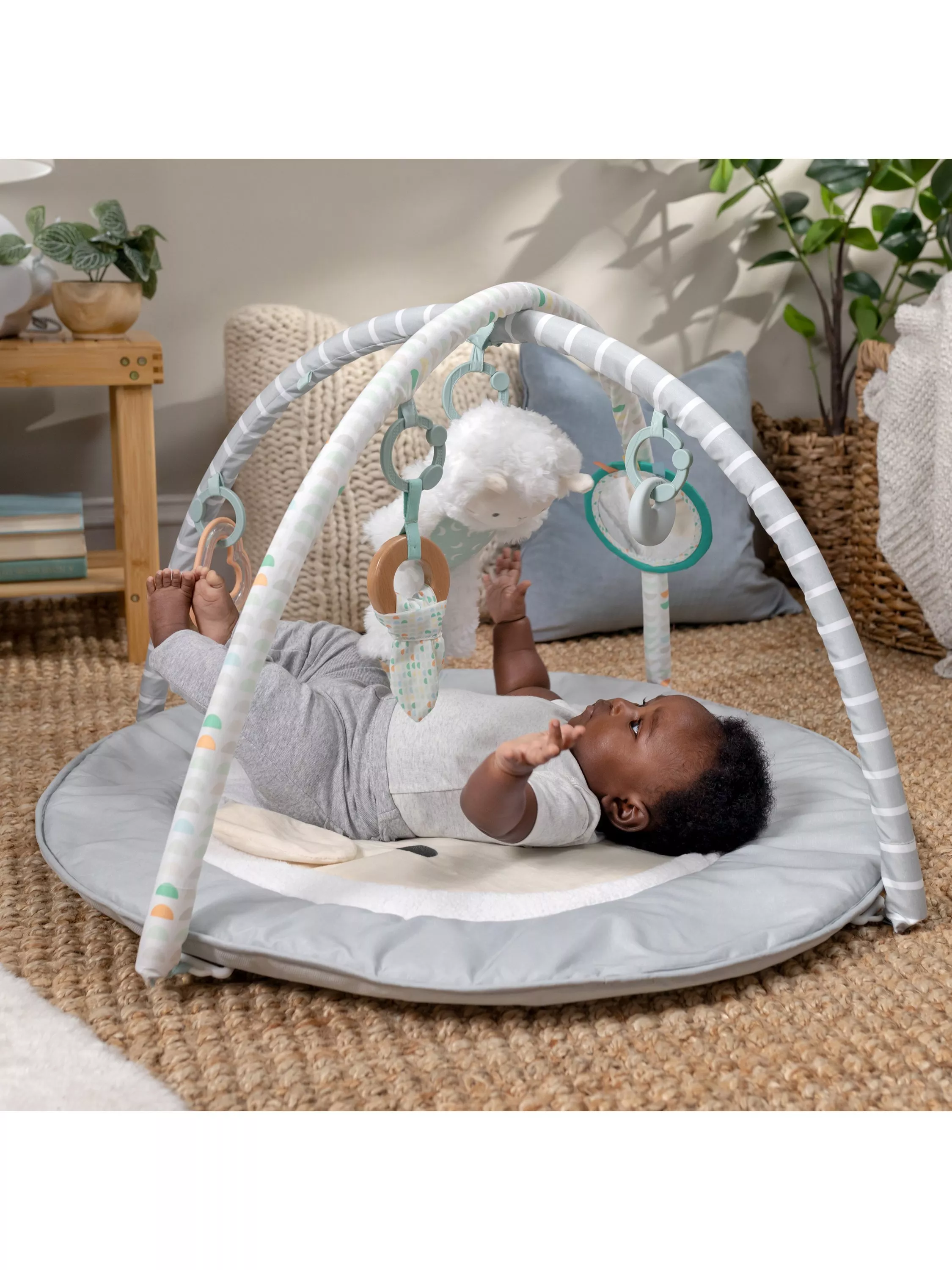 Baby on a cushioned activity gym play mat