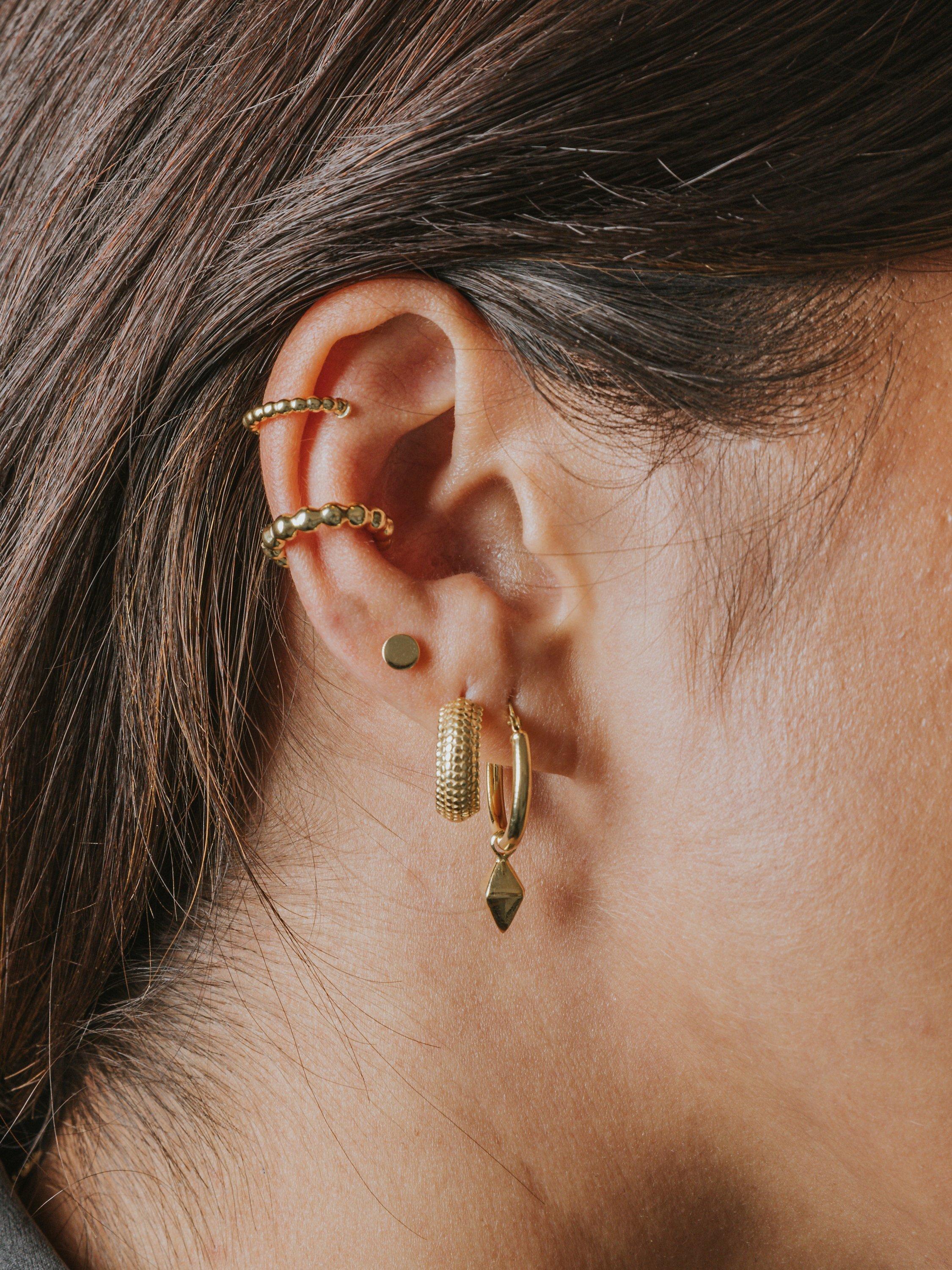 Product image 2 of 3, which shows LARNAUTI Textured Demi Hoop Earrings, Gold