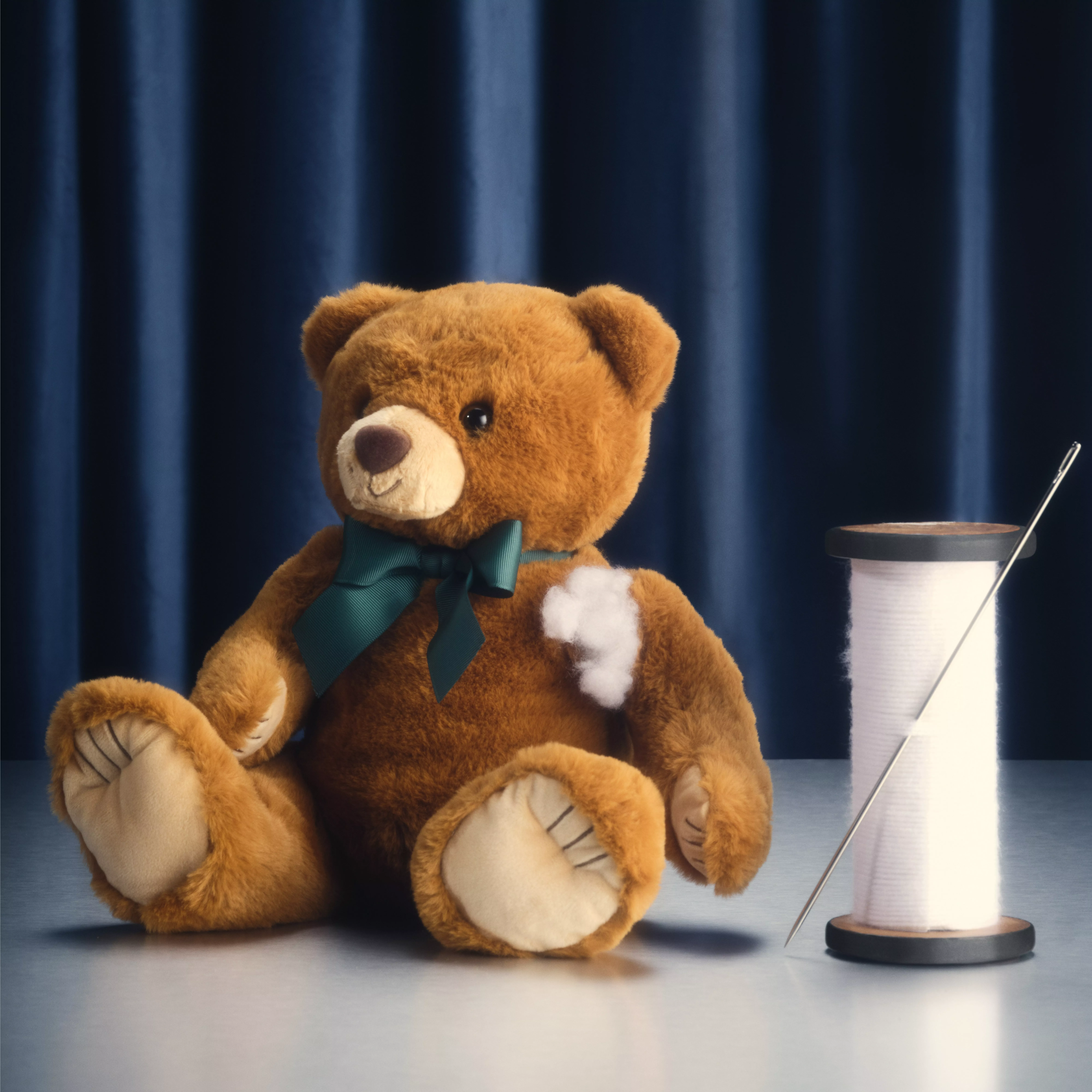 teddy bear wearing a green bow