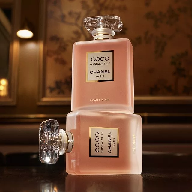 Chanel perfume bottles on white background, including No. 5 Eau de Parfum and Chance fragrance display