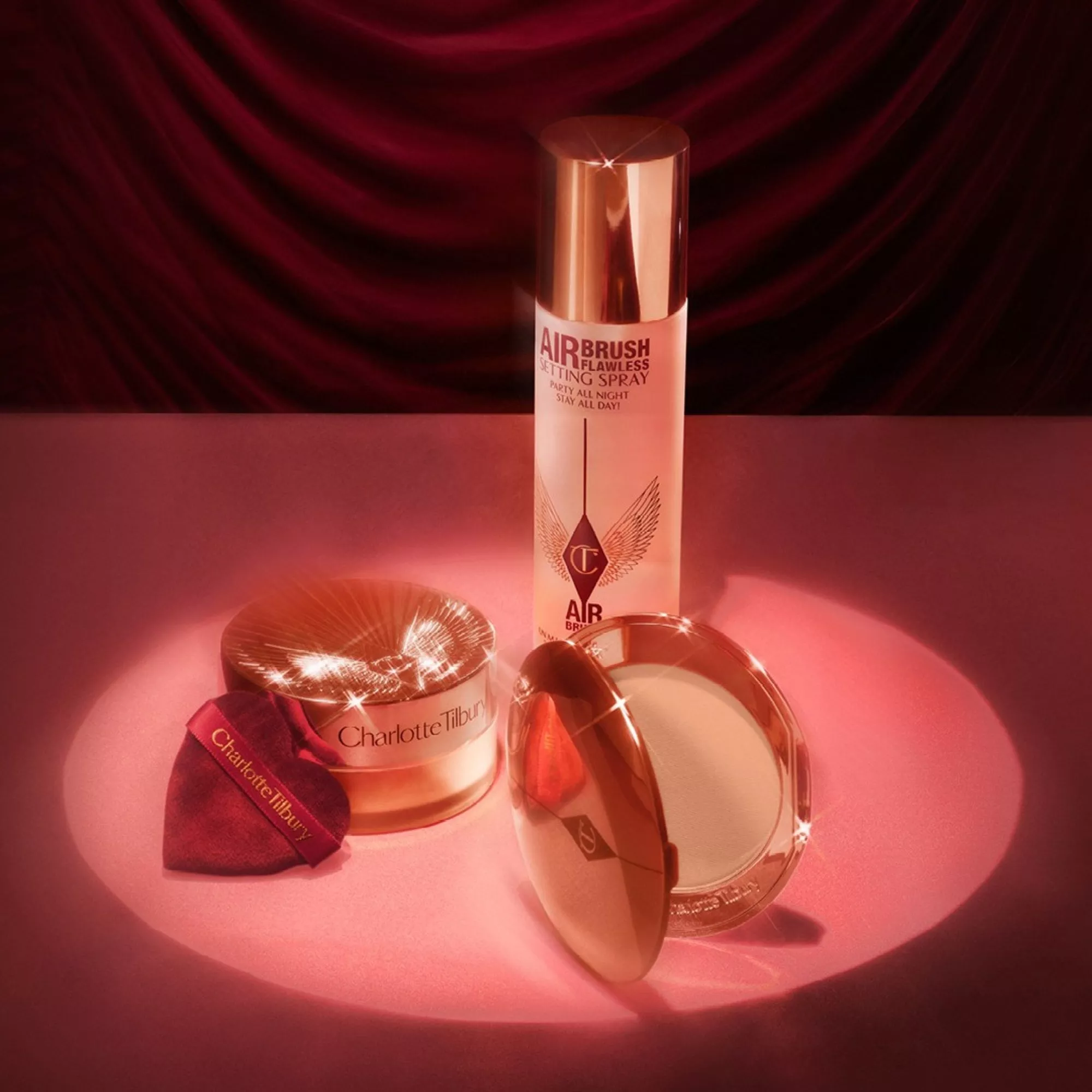 Charlotte Tilbury Airbrush Flawless setting spray, powder and brush makeup set in rose gold packaging.