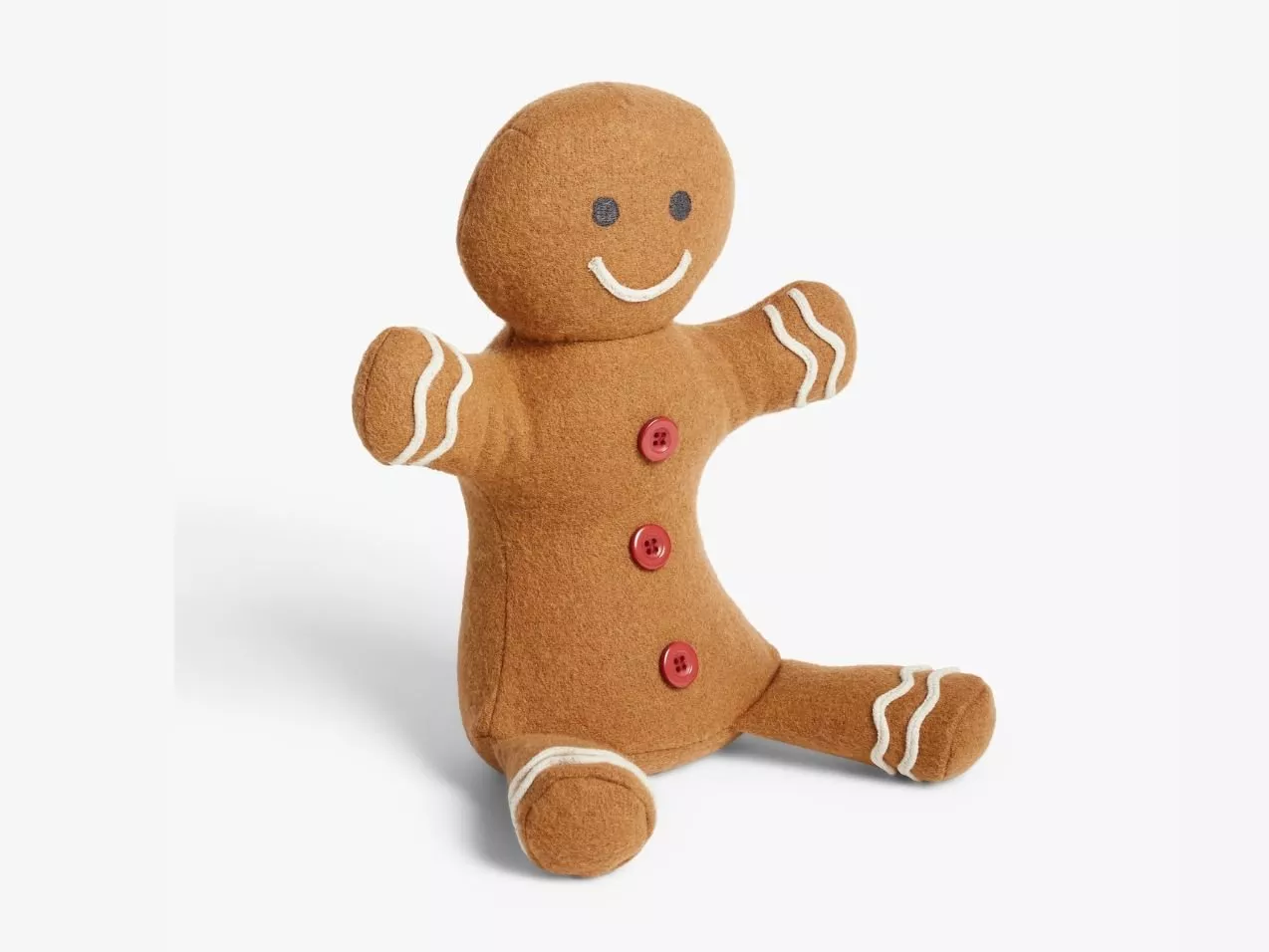 Smiling gingerbread man soft toy with red buttons and white icing trim, sitting on a clean white background