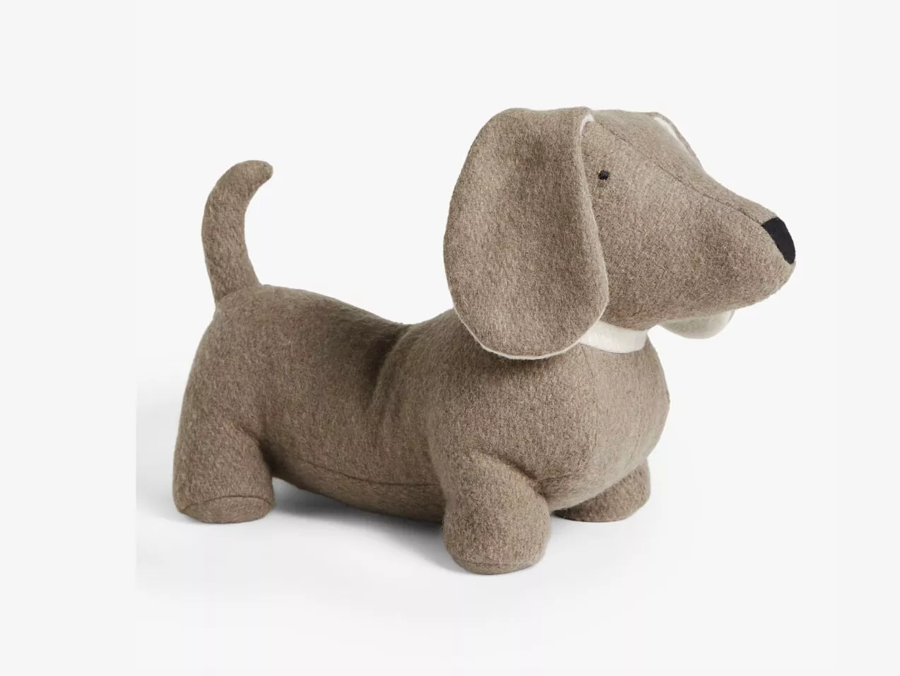 Soft dachshund doorstop in grey felt fabric, standing on white background, cute sausage dog home accessory