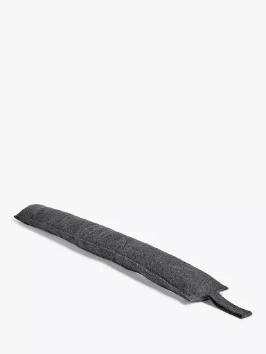 Charcoal grey fabric door draught excluder with carry handle, long slim draft stopper on white background