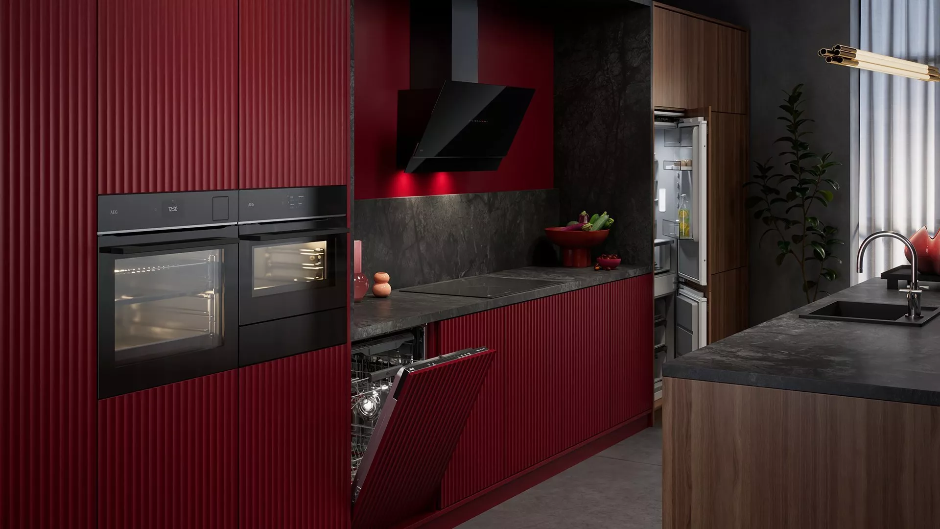 A modern, high-end kitchen featuring bold burgundy-red ribbed cabinetry and dark grey stone countertops.