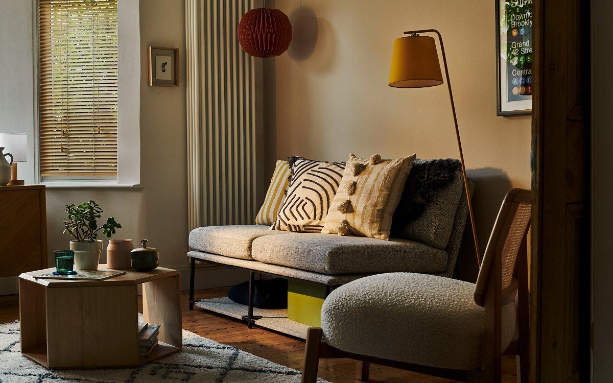 sofa, armchair, bookshelf, framed orange artwork, coffee table