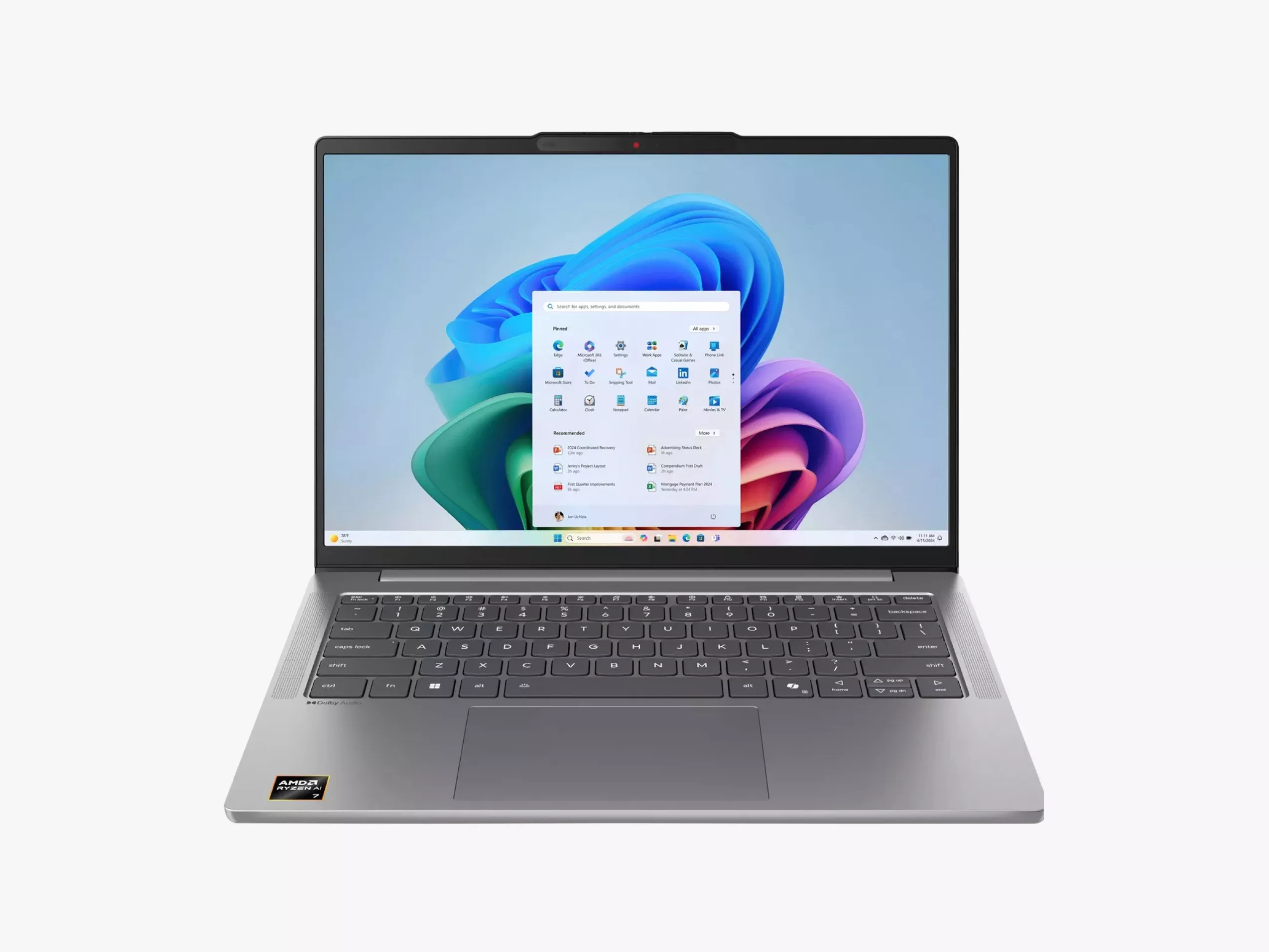 Silver laptop displaying a Windows 11 desktop screen with vibrant coloured graphics and various icons.