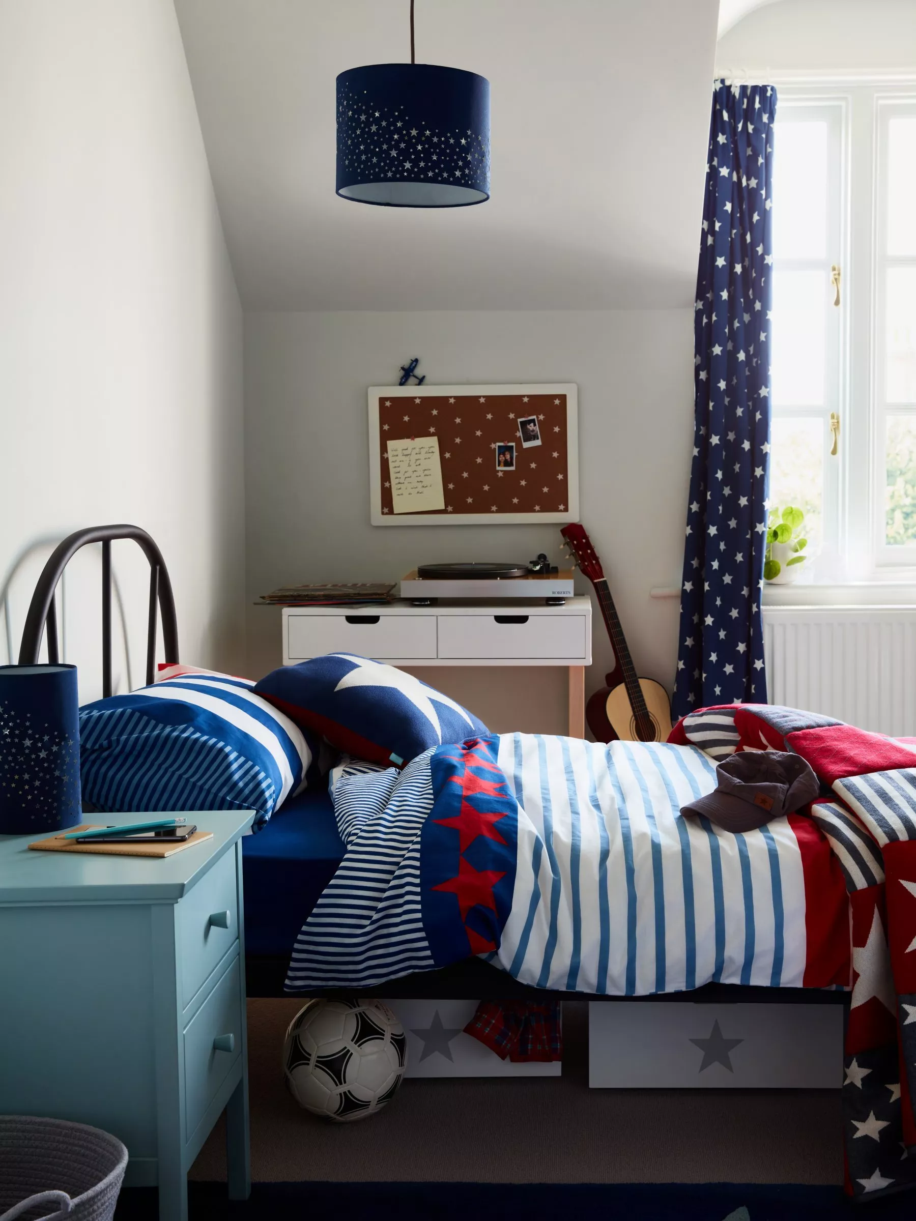 kids bedroom with colourful red white and blue bedding with stars on