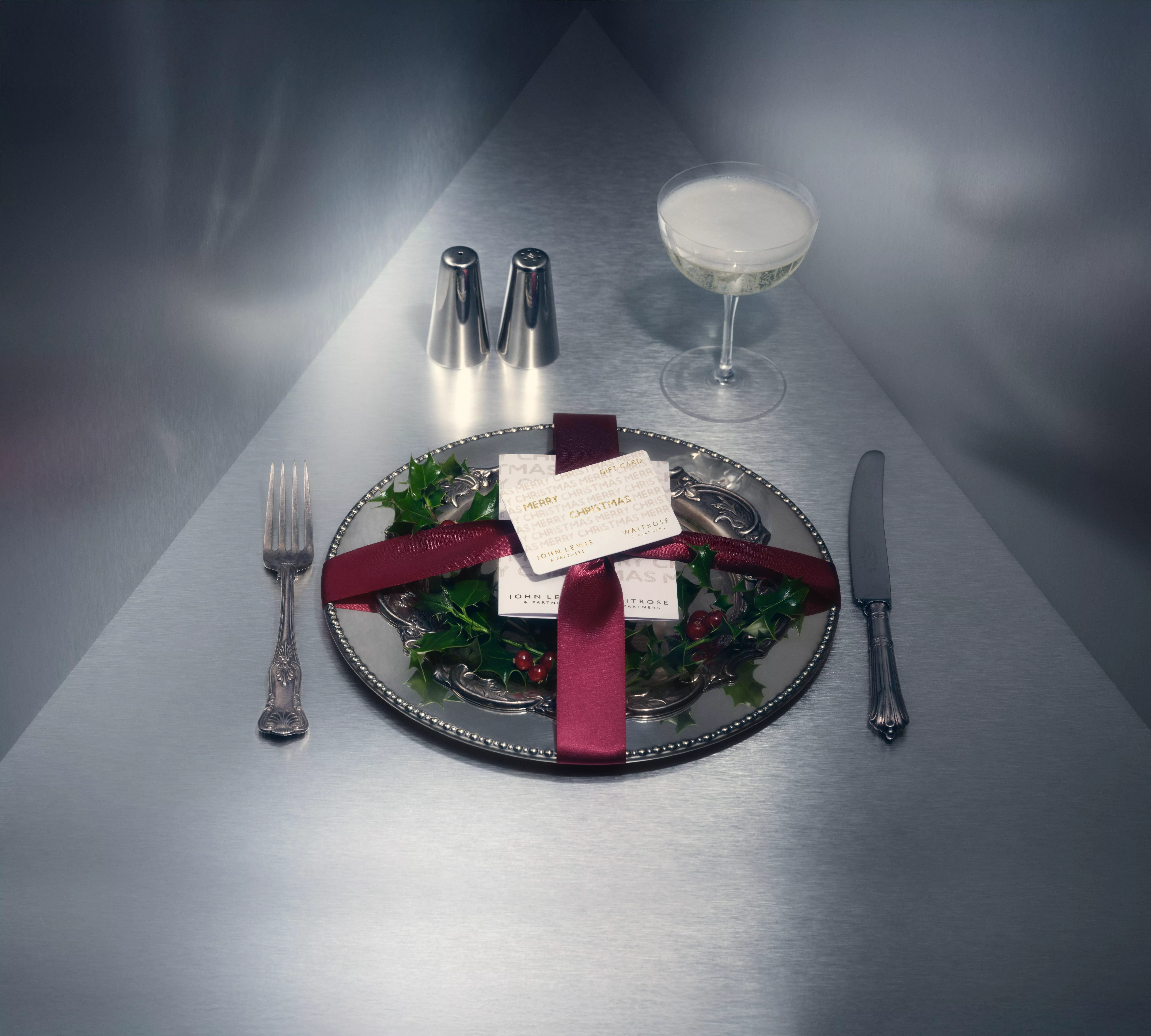 Silverware placesetting wrapped in a bow with a gift card placed in the centre