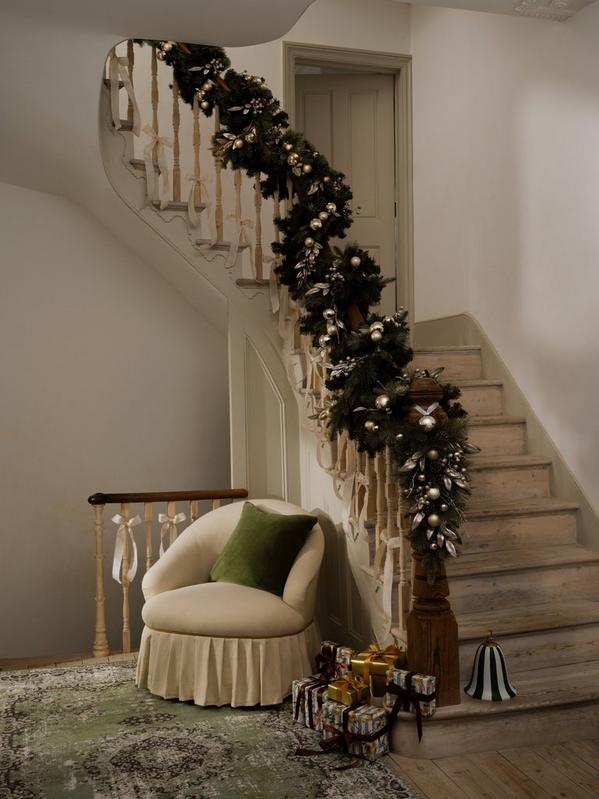 Staircase being decorated with Christmas decorations