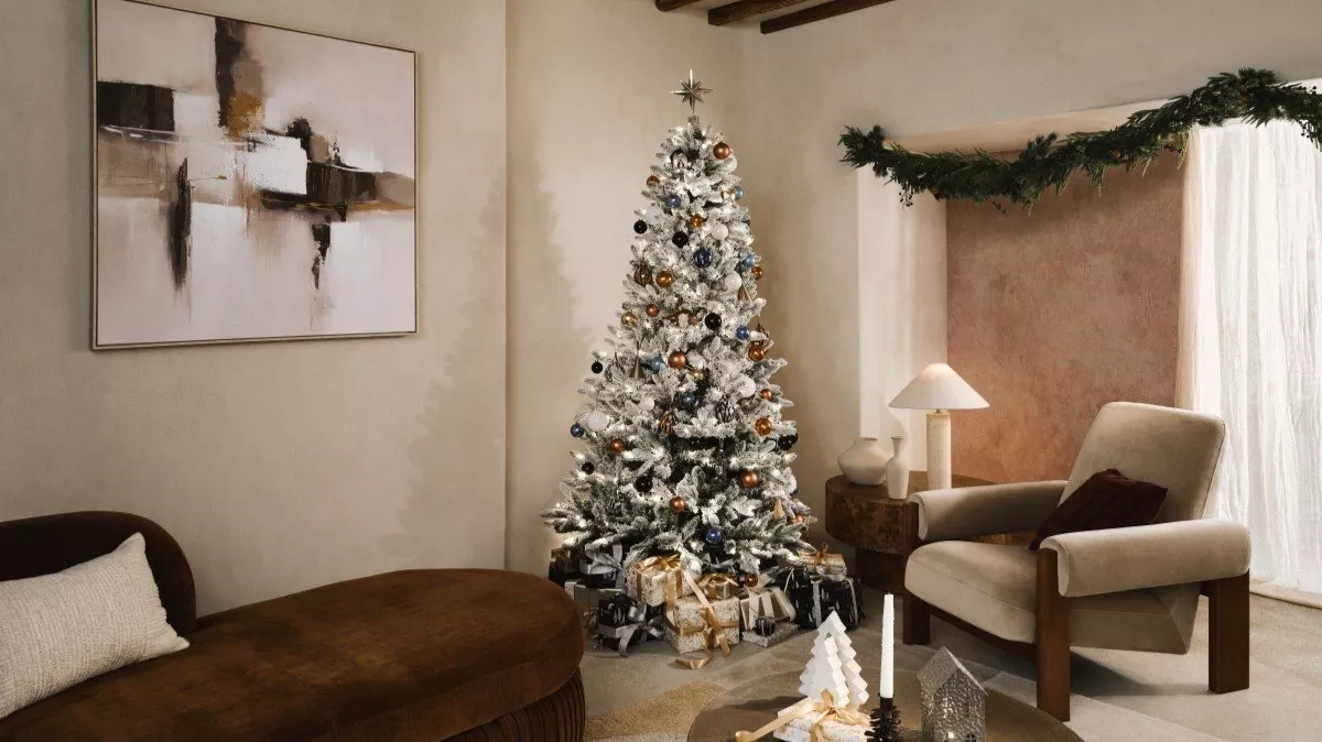 Christmas tree in a living room with armchair and sofa
