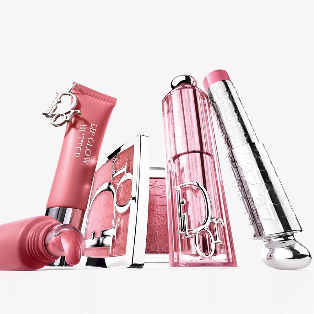 Dior pink lip glow butter, blush compact and lipstick arranged on white background, luxury makeup set close-up