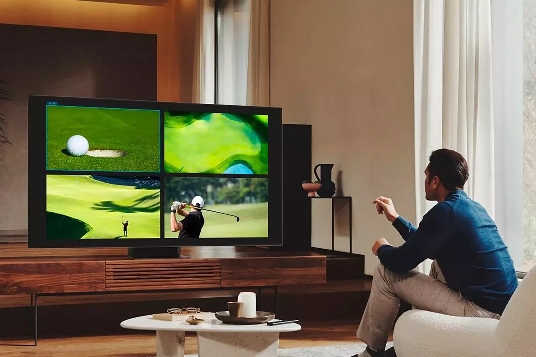 Person watching golf on a TV