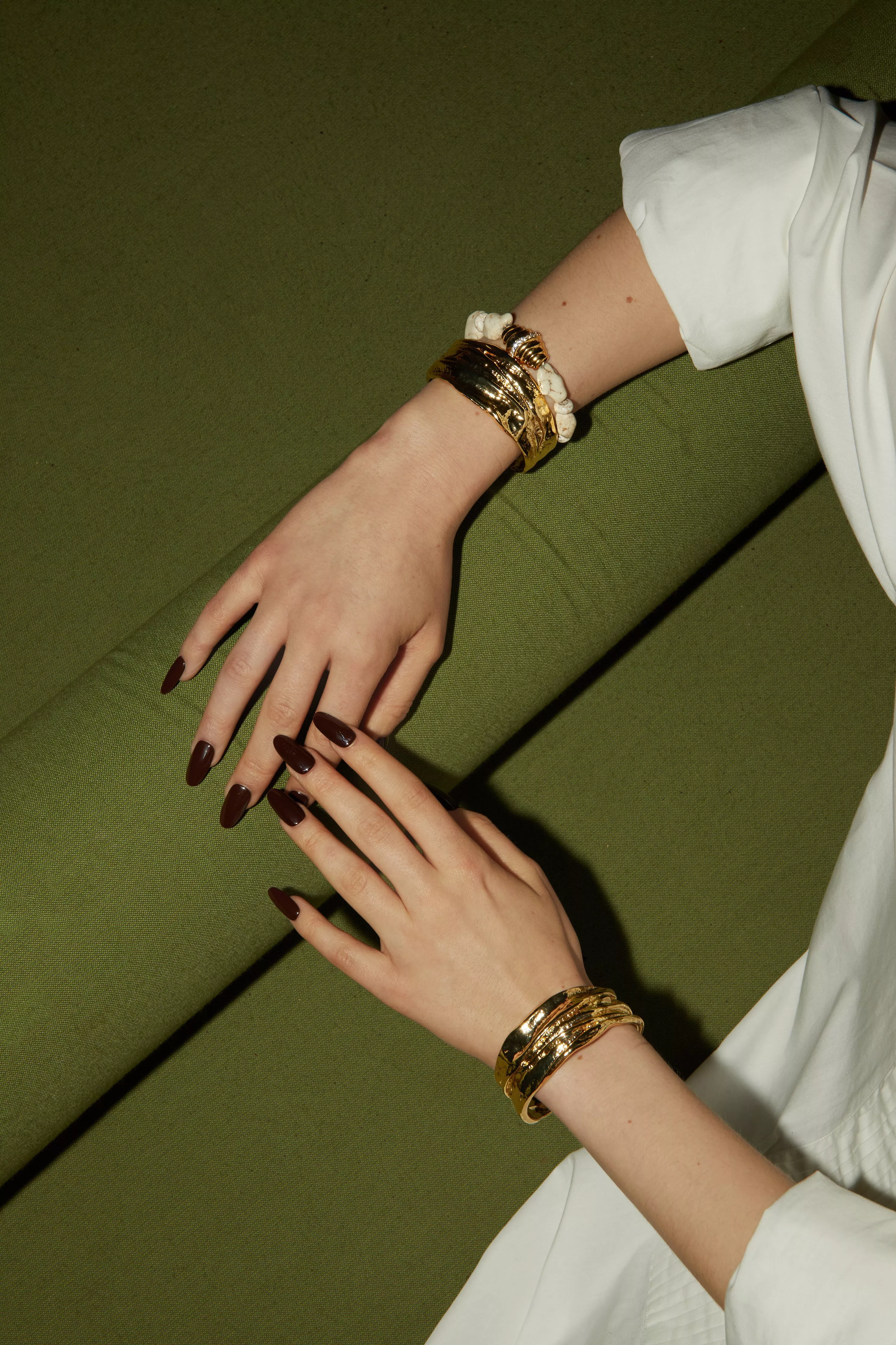 woman wearing layered gold bangles