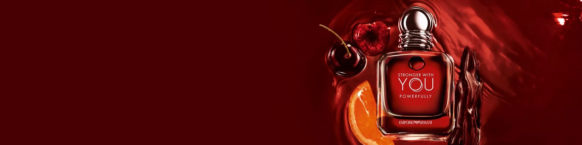 Luxurious red-themed perfume bottle with cherry, orange slice, and spice accents, evoking a rich fragrance.