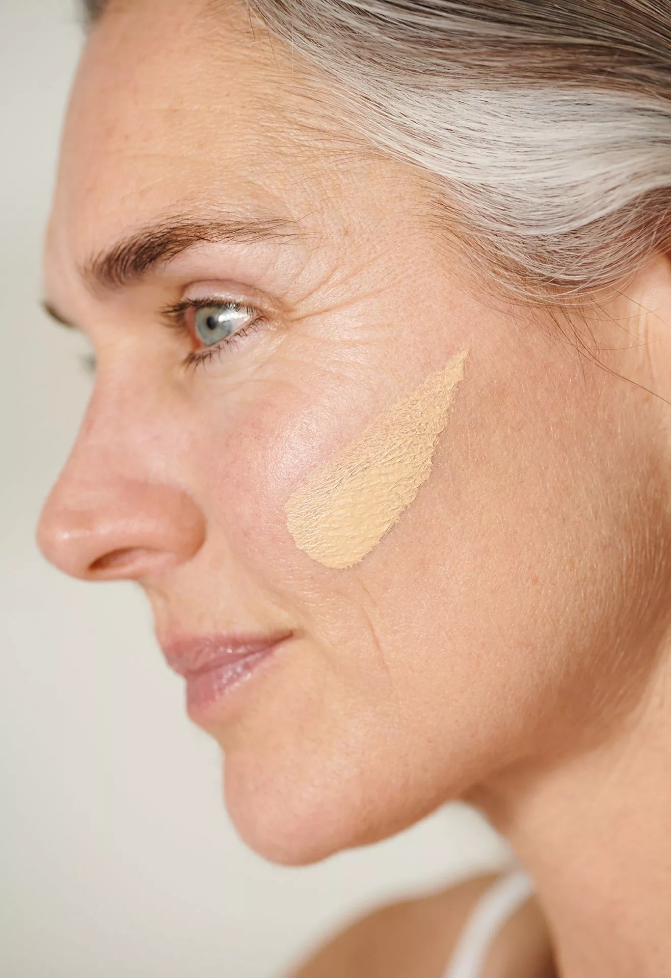 Person with a swatch of foundation on their face
