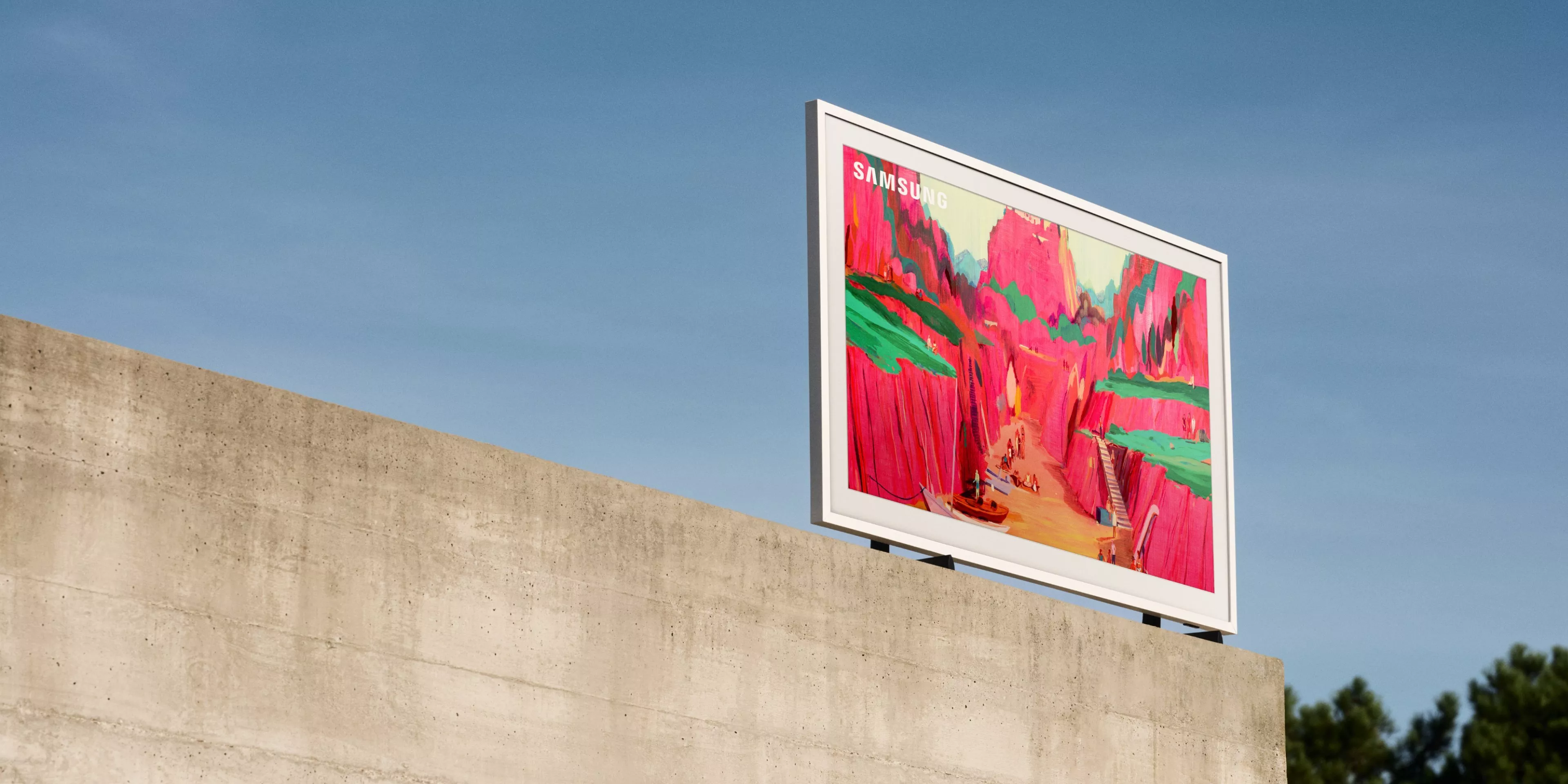 Samsung TV displays vibrant landscape art against a clear blue sky, mounted on a concrete structure.