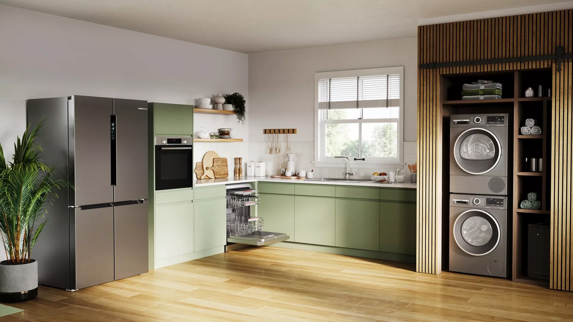 Modern open-plan kitchen with integrated dishwasher, fridge freezer and built-in laundry cupboard with washer dryer