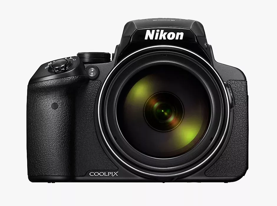 Front view of Nikon Coolpix camera showing lens and controls on a textured black body against a plain background.