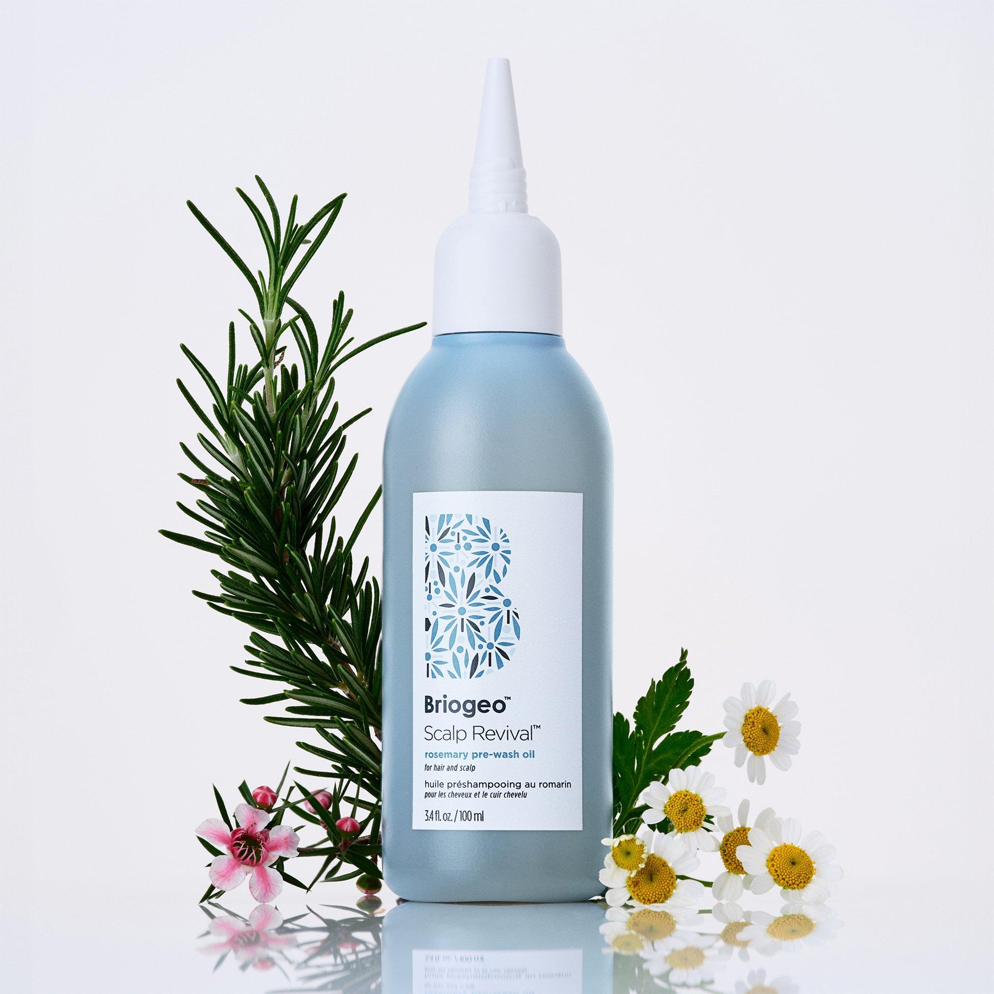 Briogeo Scalp Revival™ Rosemary + Bisabolol Pre-Wash Oil surrounded by flowers