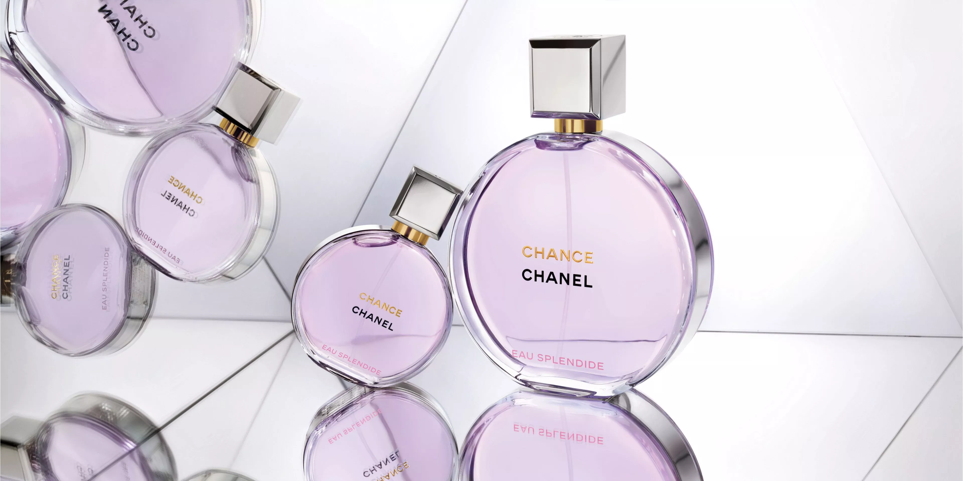 two pale purple CHANEL CHANCE bottles positioned on a mirror surface