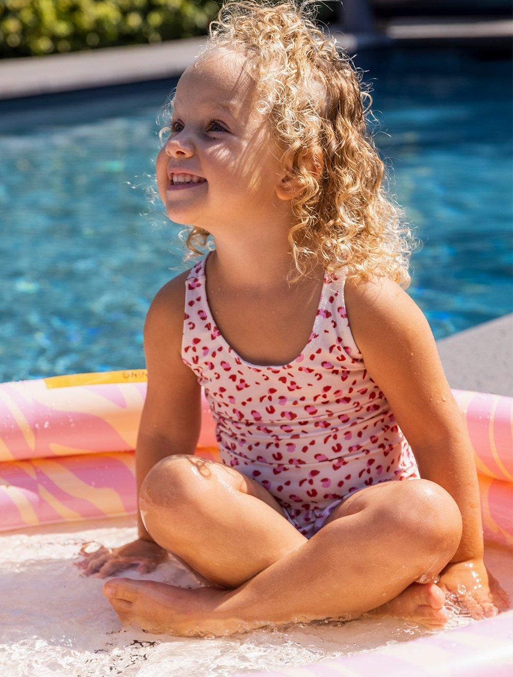 a girl wearing a swim essential swimming costume