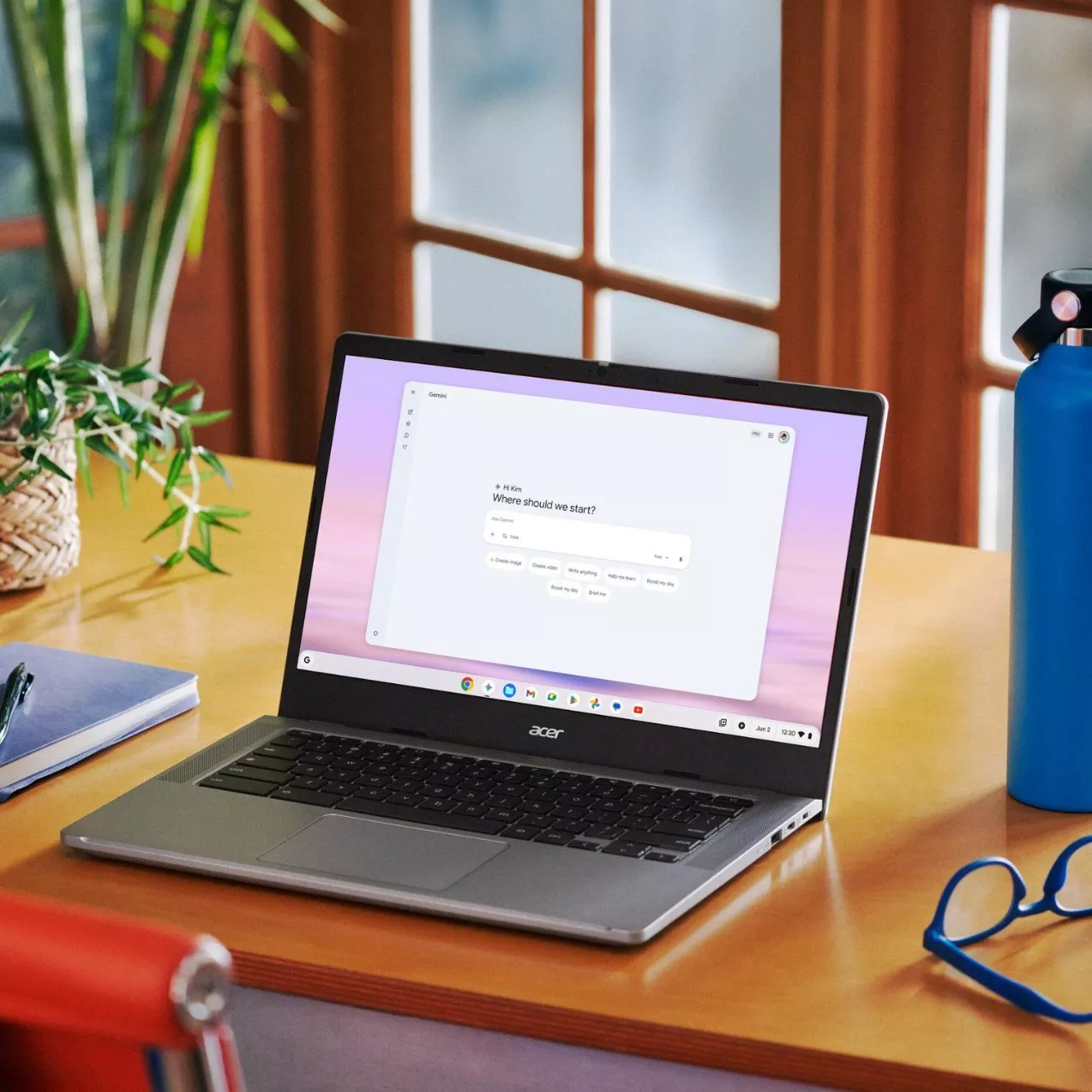 A young woman with curly red hair sitting in warm, cozy lighting and typing on a laptop displaying graphic novel images.