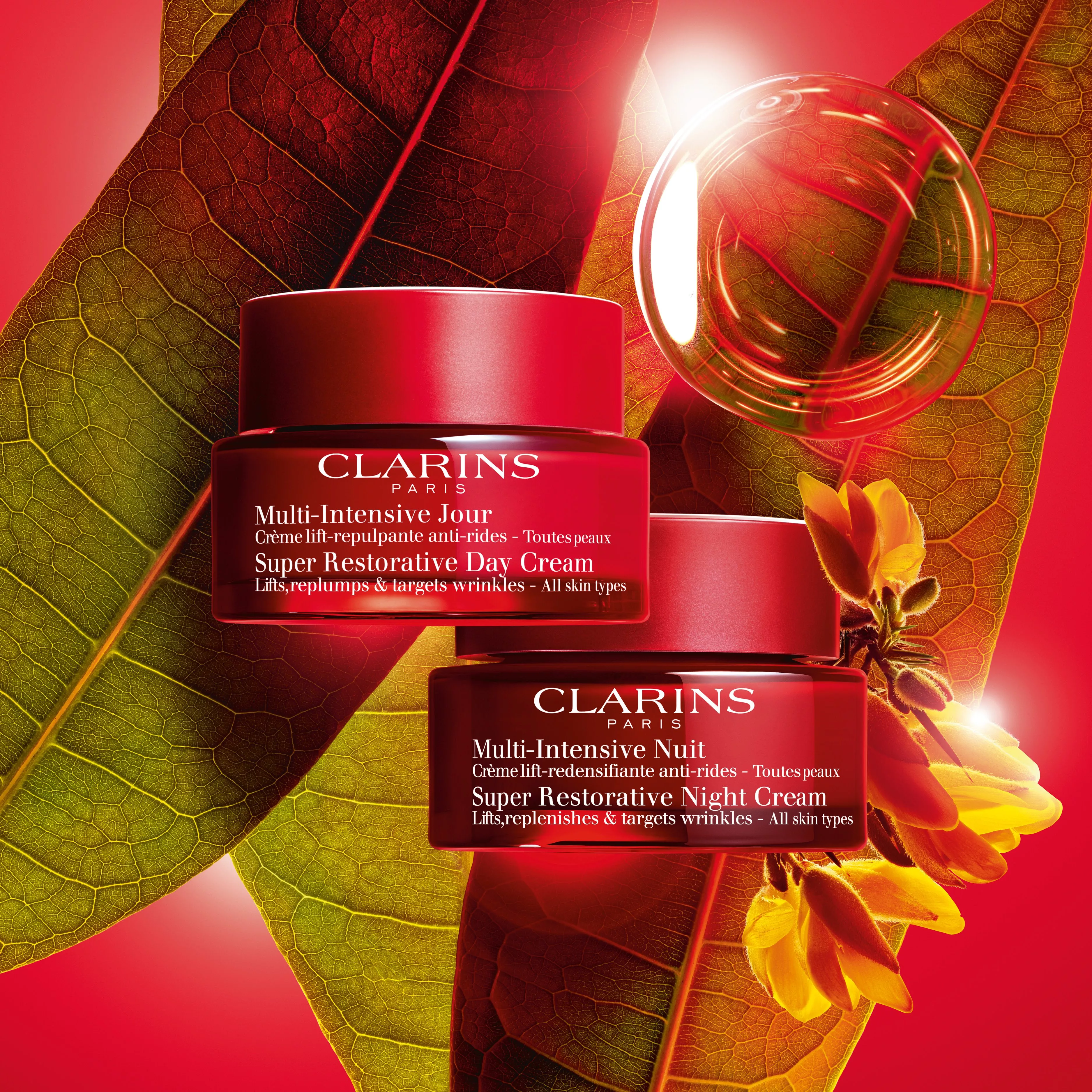Clarins Multi-Intensive Day and Night Cream jars on leaf backdrop with glowing serum bubble, skincare ad
