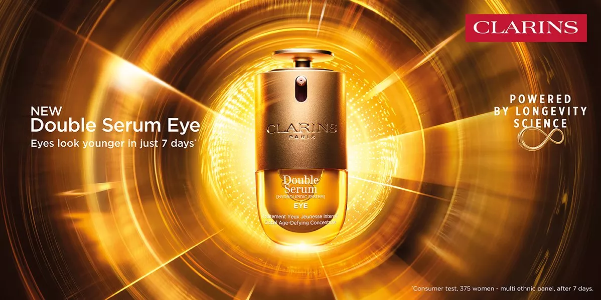 A brand banner for Clarins showcasing their new double eye serum