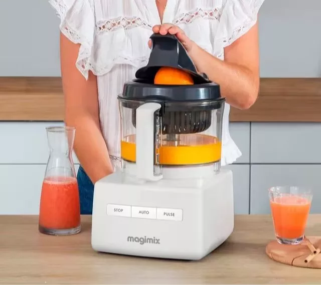 sliver delonghi toaster with toast and eggs on a brown mini tray