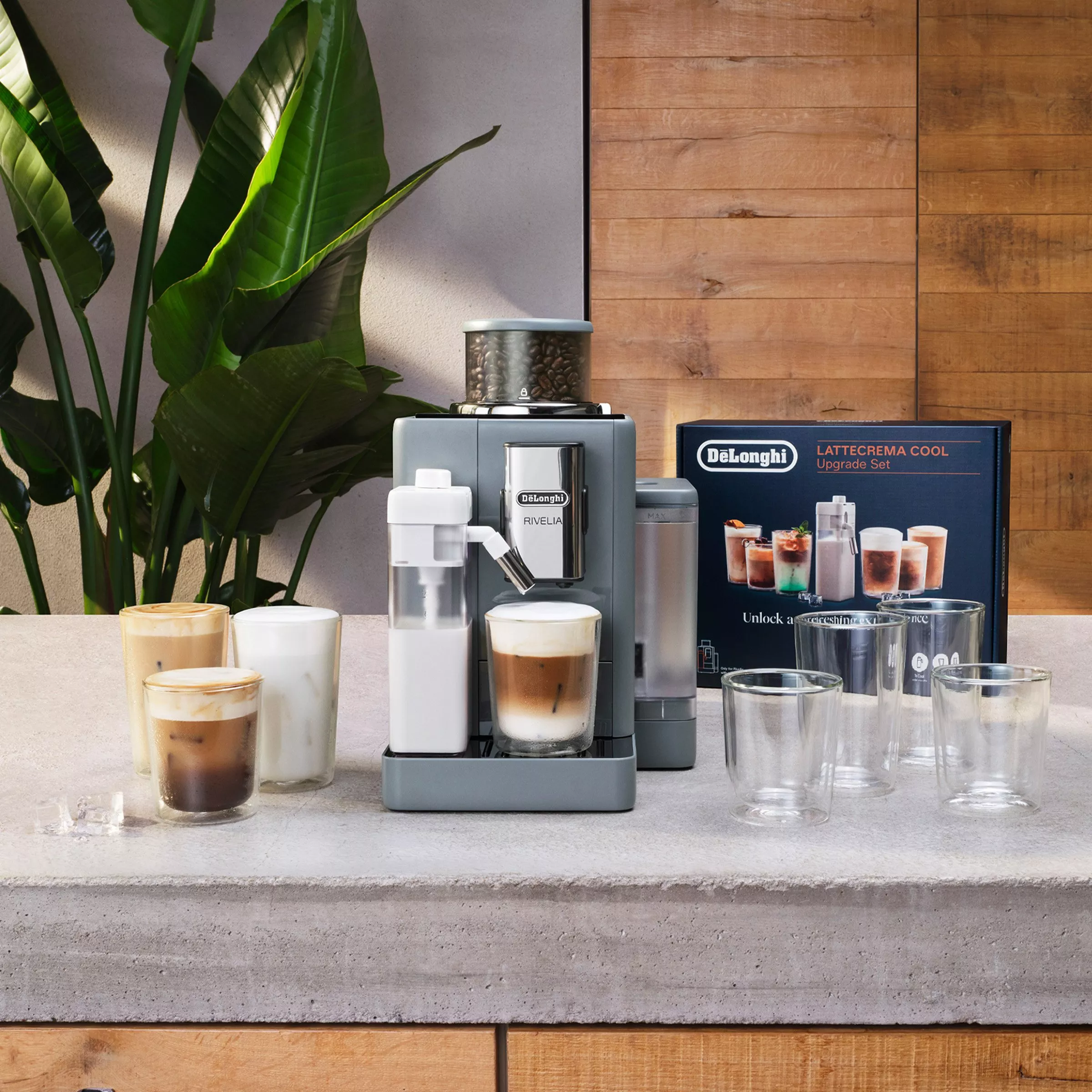 De’Longhi Rivelia coffee machine with LatteCrema Cool upgrade set, iced lattes and glassware on kitchen counter