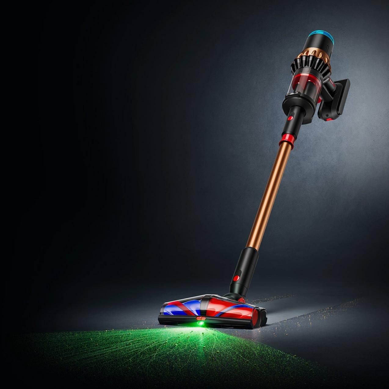 A Dyson cordless stick vacuum with a copper wand, standing upright. Its cleaner head emits a bright green laser light revealing dust on a dark floor against a moody background.