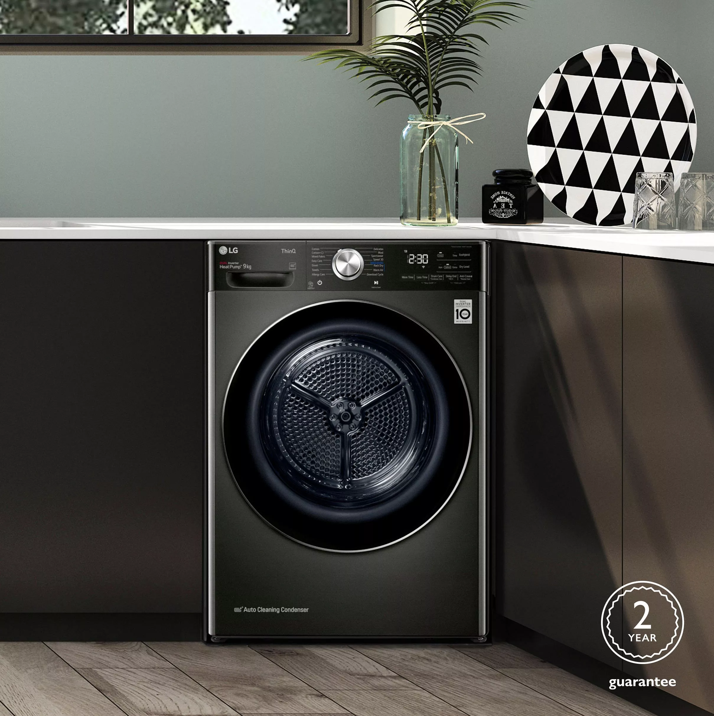 Black tumble dryer built into kitchen 