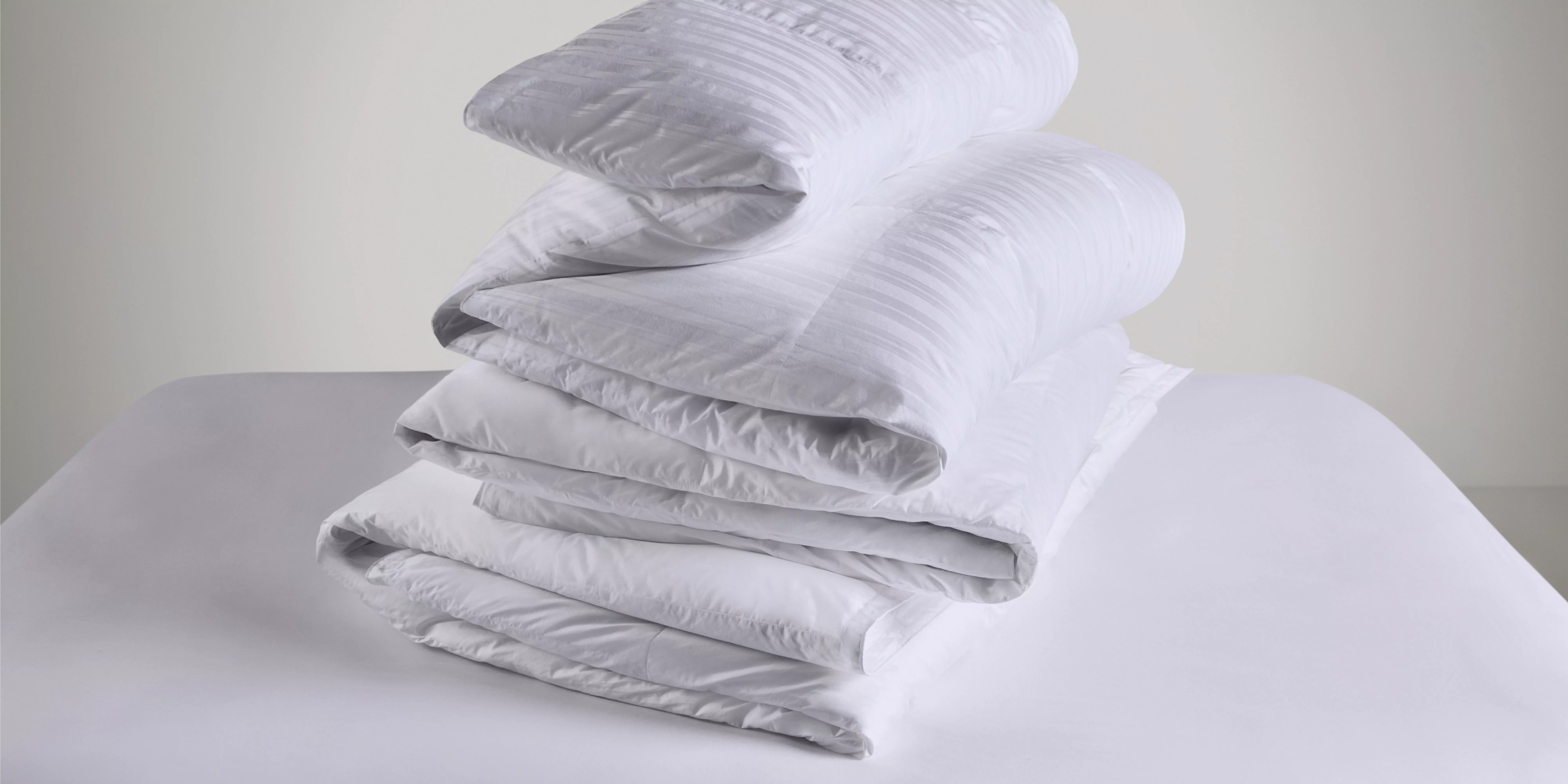 Mattress with fur throw on and pillows