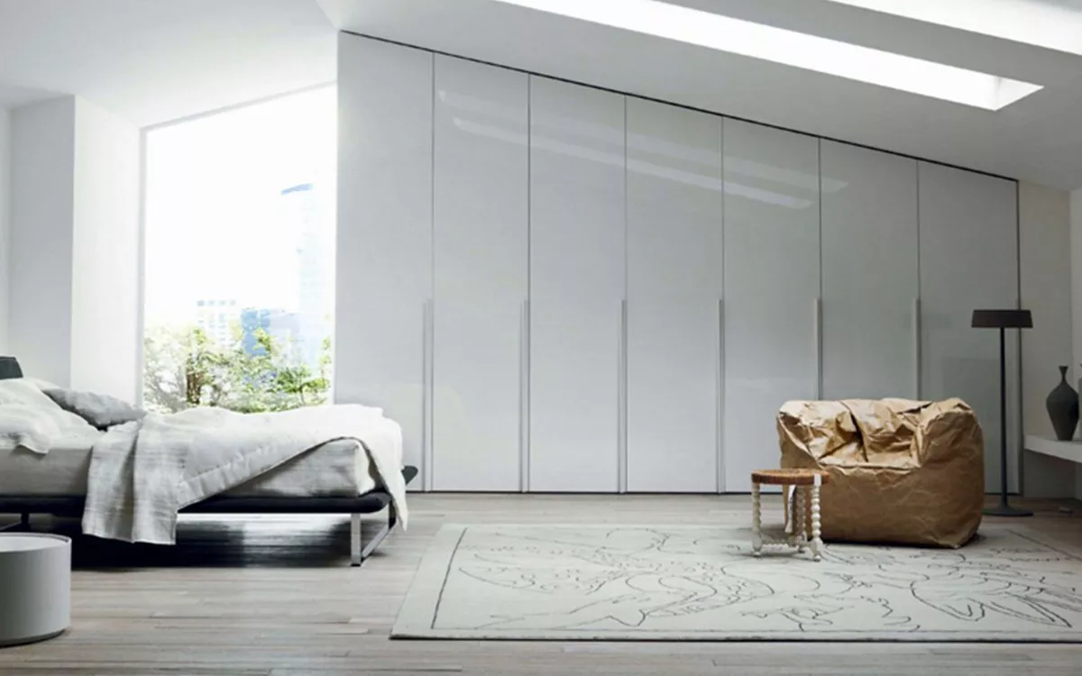 Bedroom with fitted wardrobes along the back wall 