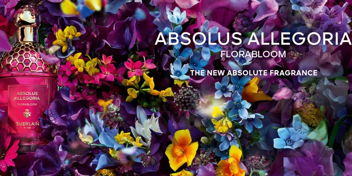Showing Guerlain brand banner with a perfume bottle on a flower background.