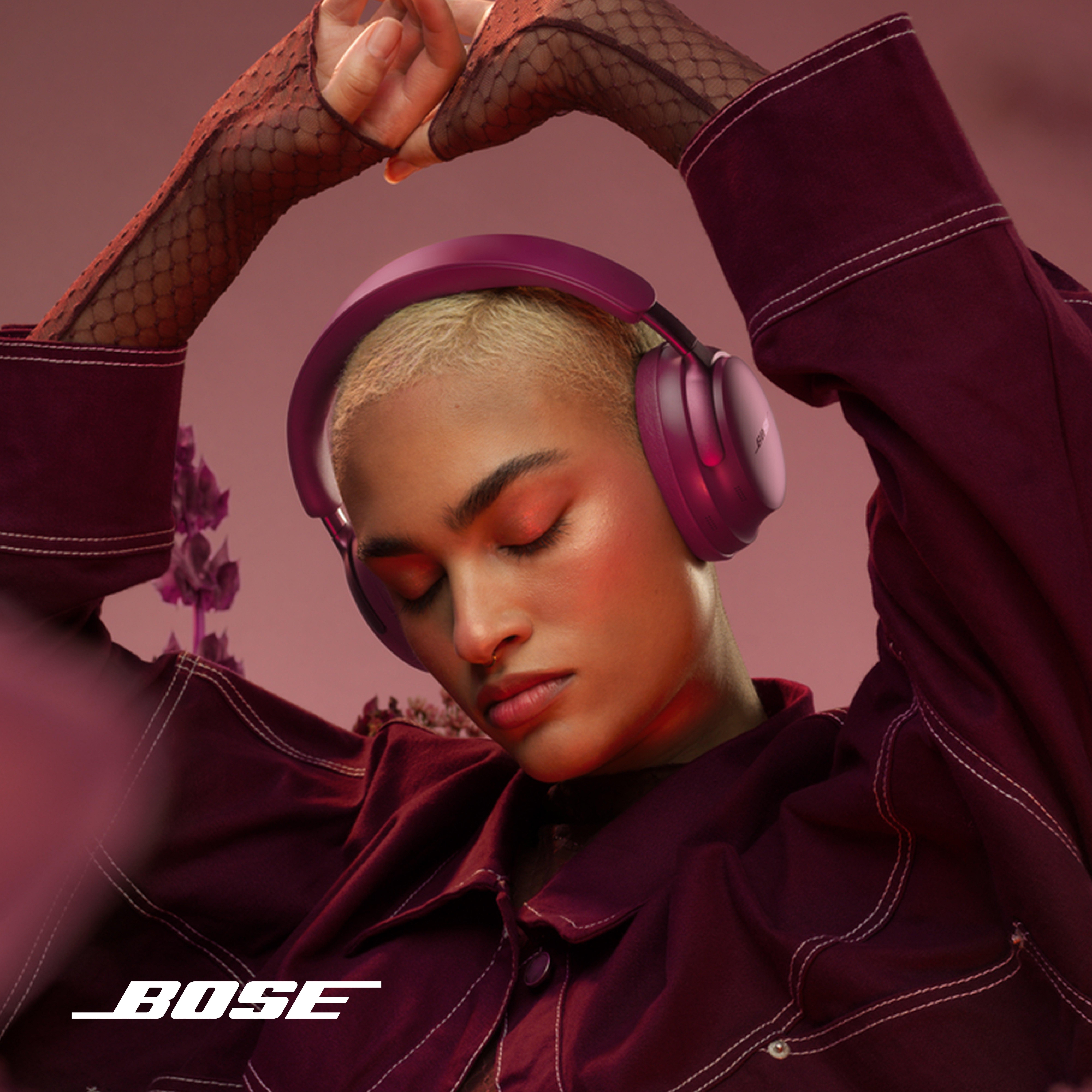 a dancing women wearing dark pink jacket bose headphones